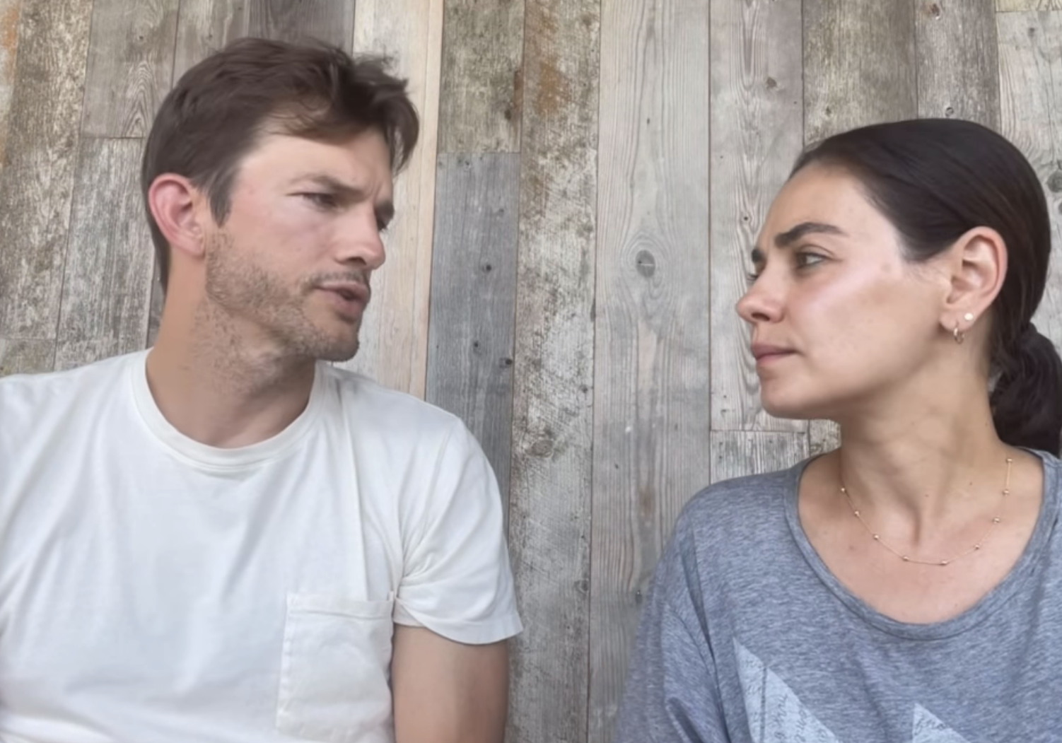 Close-up of Ashton and Mila looking at each other in the video