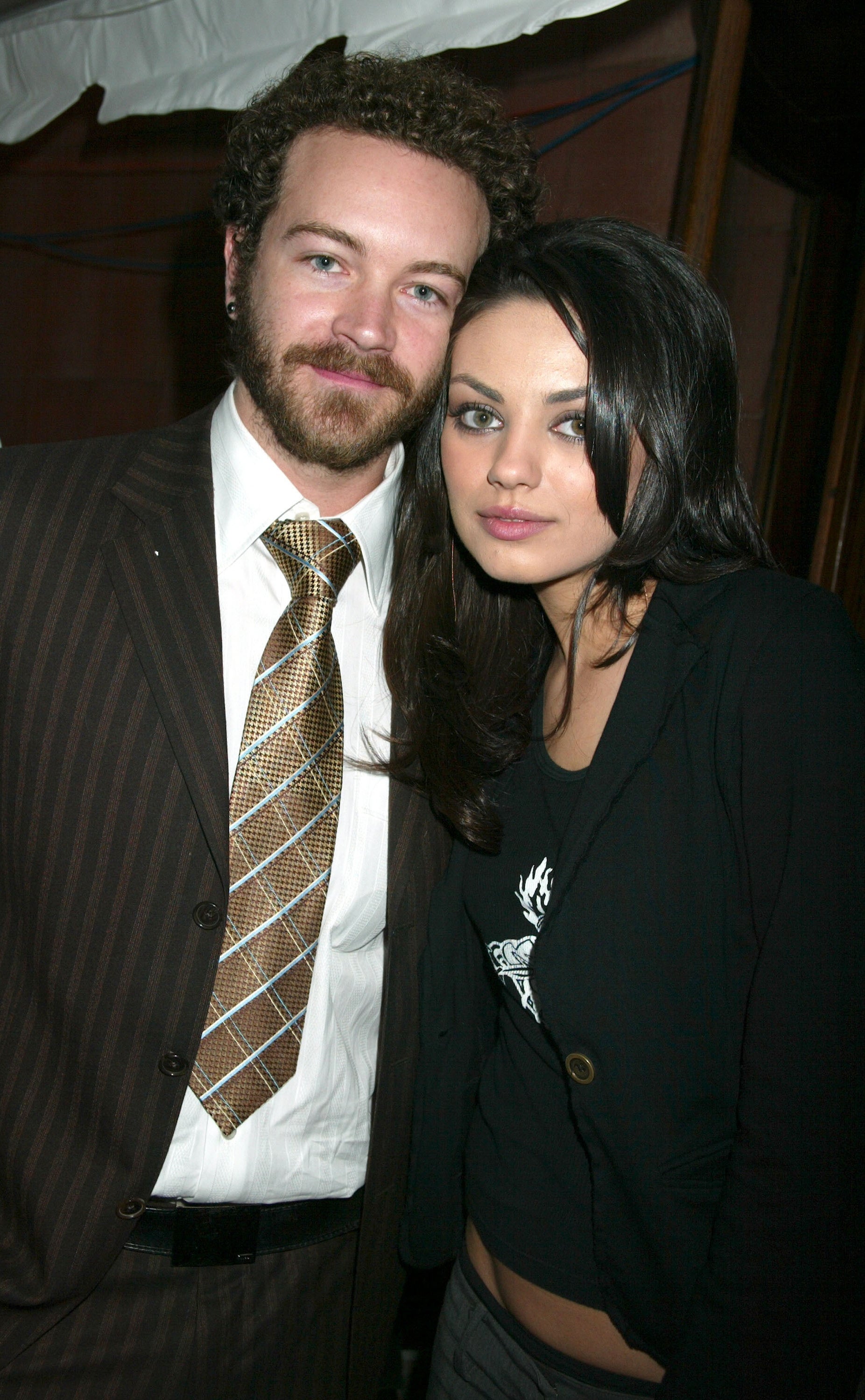 Close-up of Danny and Mila standing close together