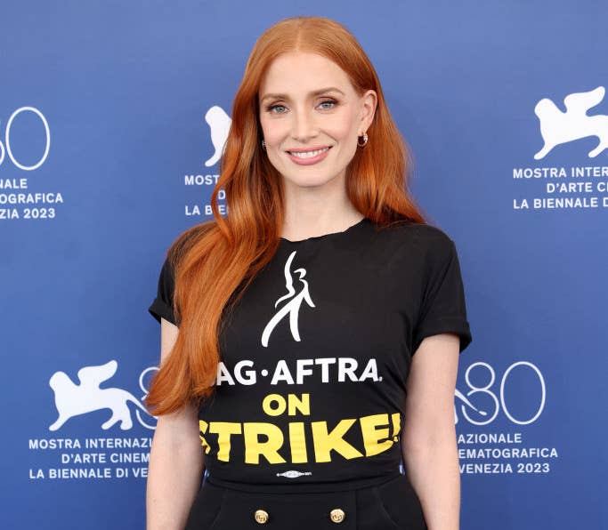 Closeup of Jessica Chastain wearing a t-shirt that says, "SAG AFTRA on Strike?"
