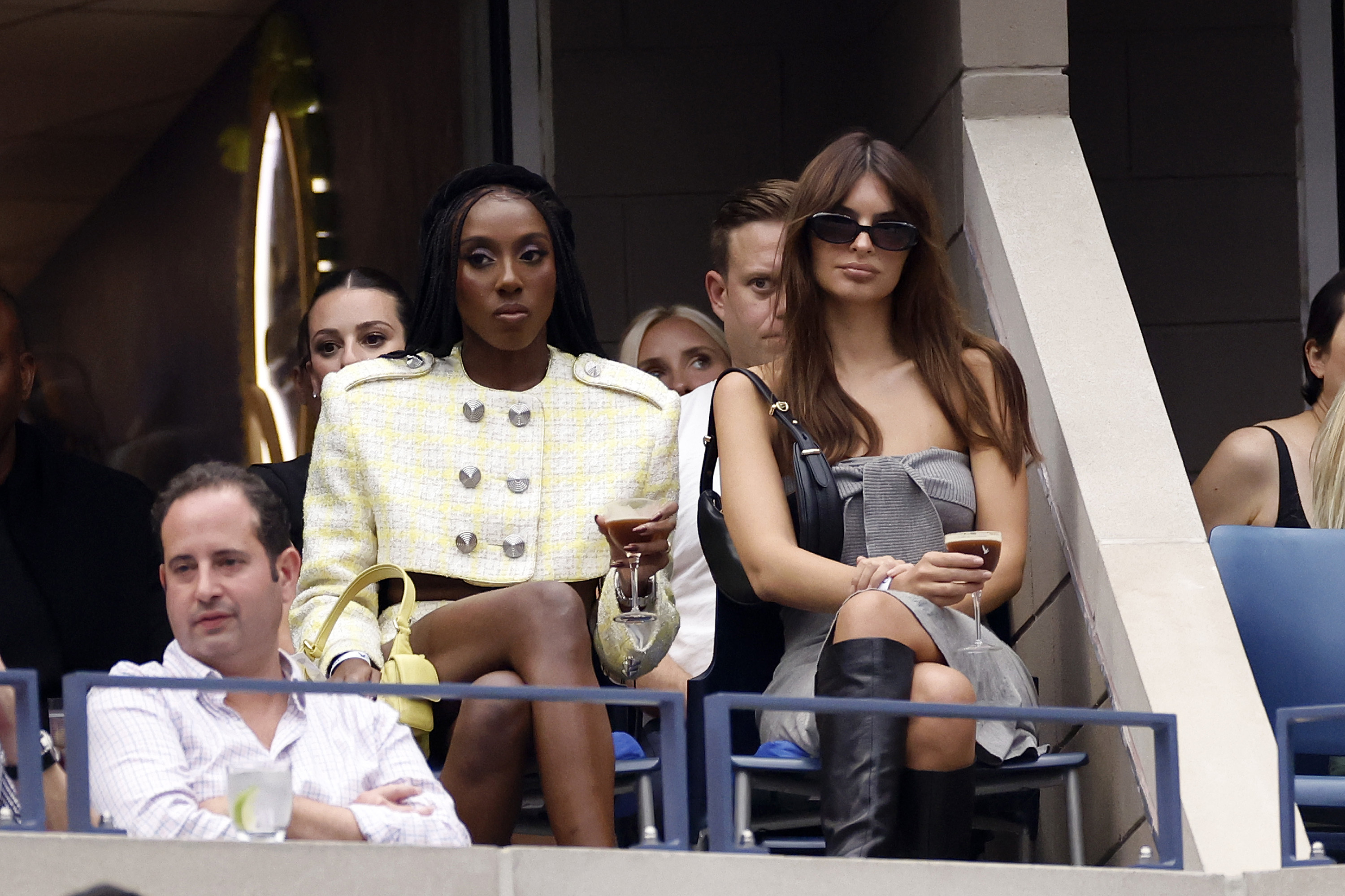 Closeup of Ziwe and Emily Ratajkowski in the audience at the US Open