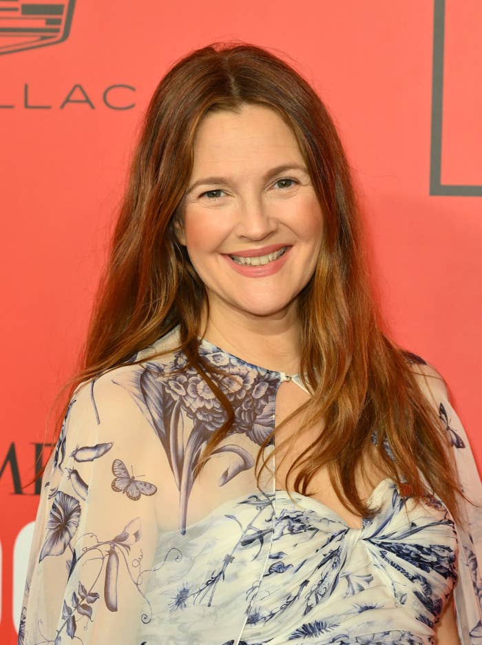 Closeup of Drew Barrymore smiling on the red carpet of a media event