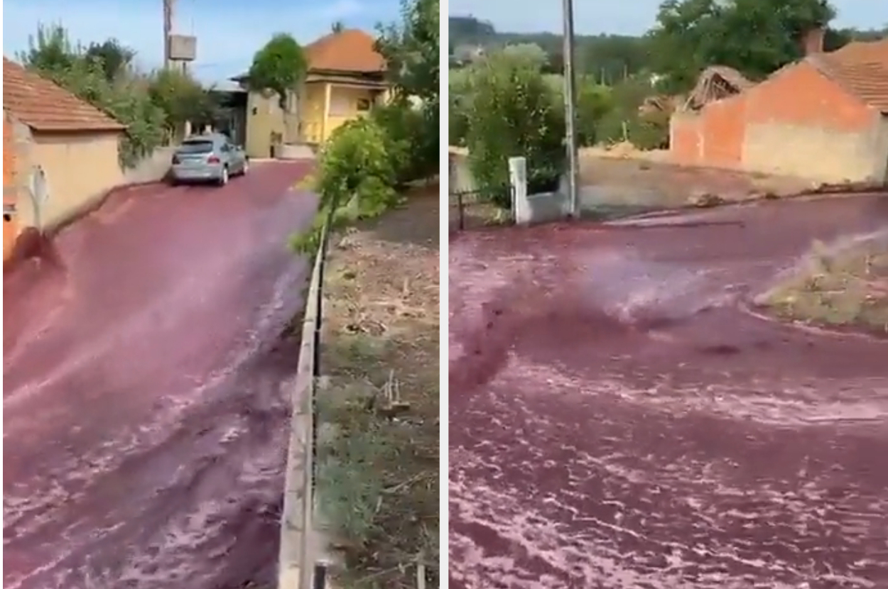 Top of hill where red wine river is flowing, car pictured parked in the river