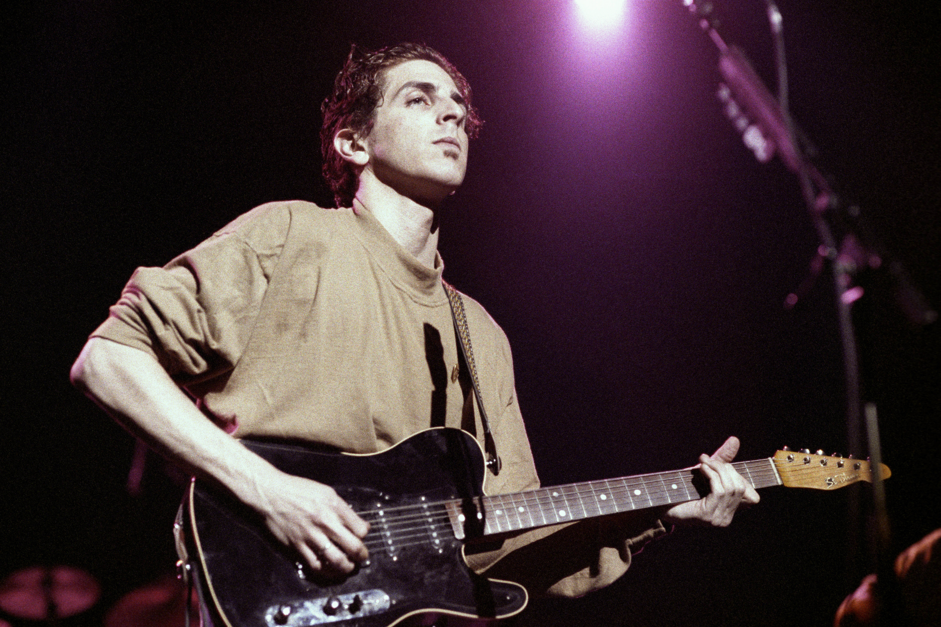Michael Penn onstage playing the guitar