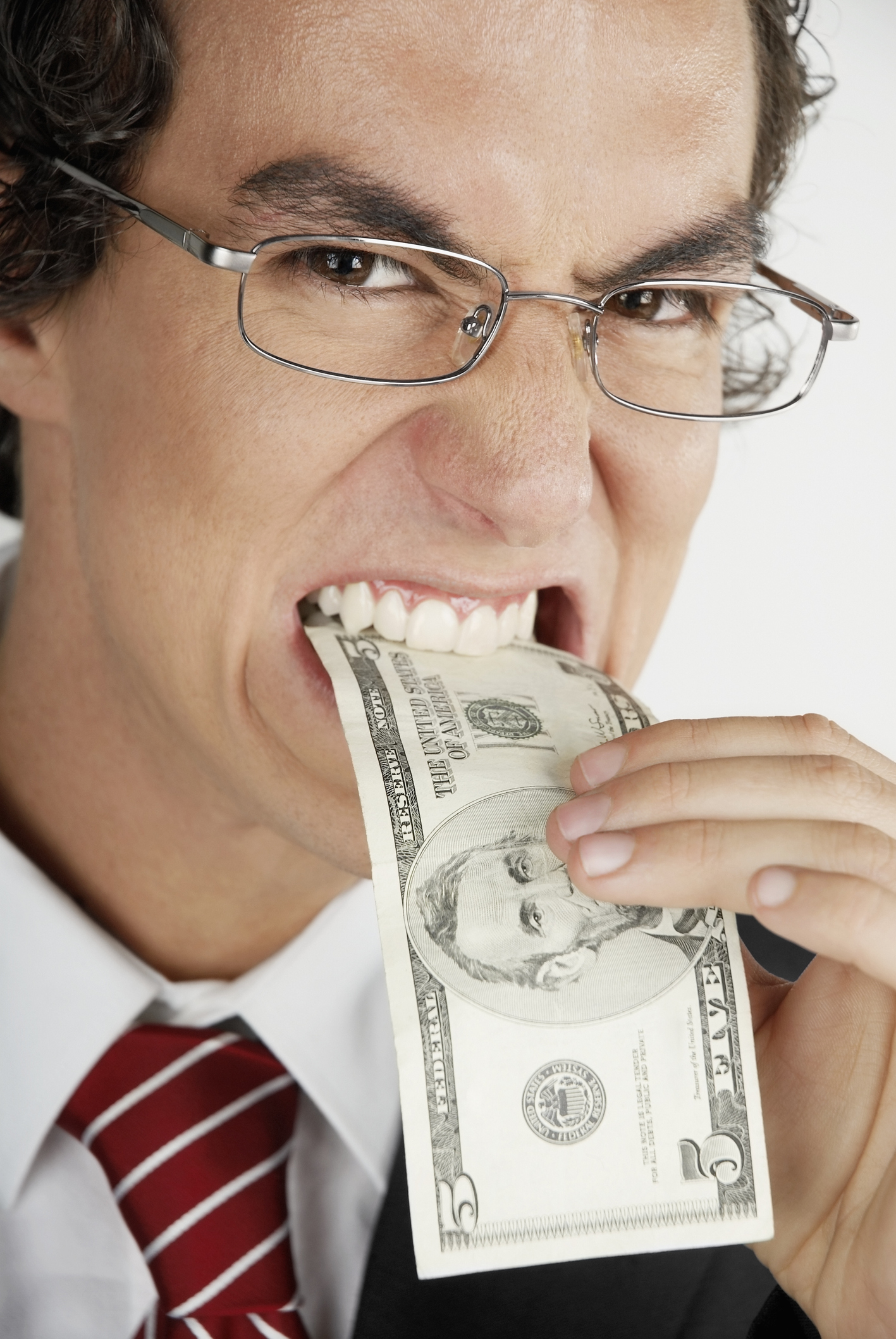 A man biting a $5 bill
