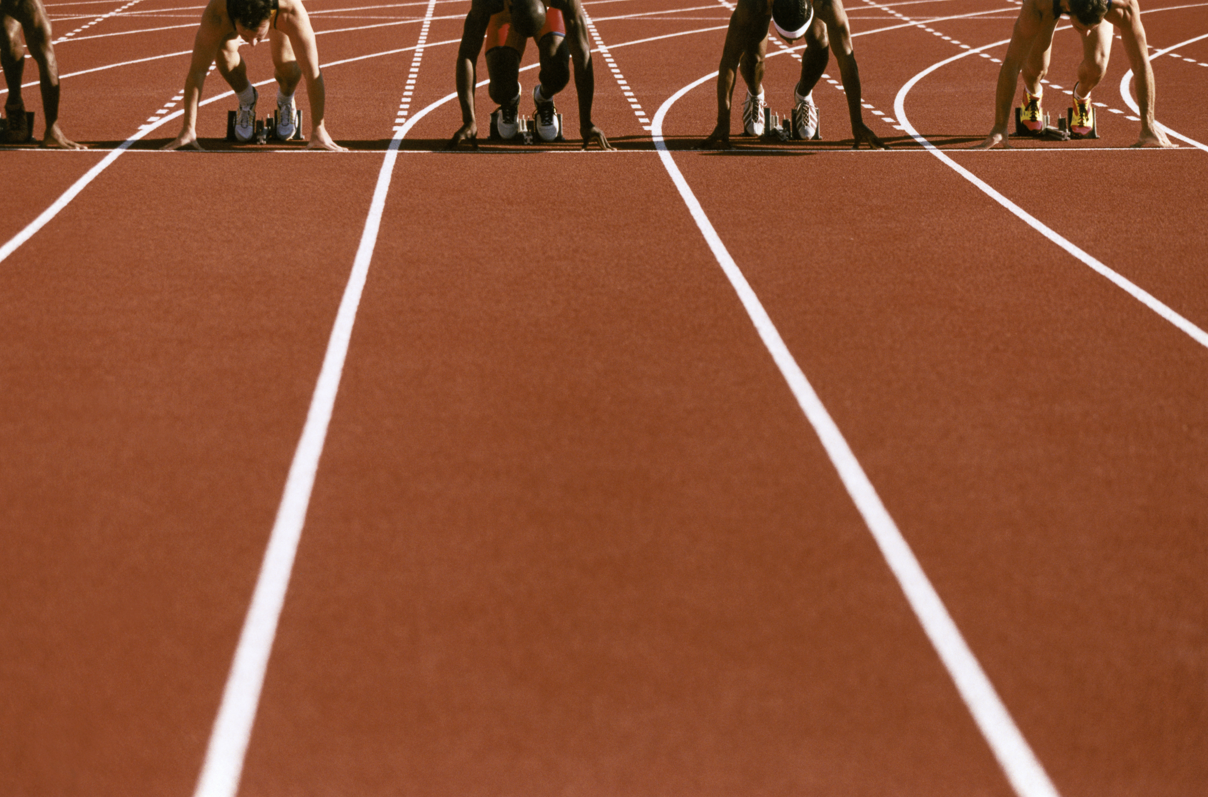 Athletes line up to race on a track