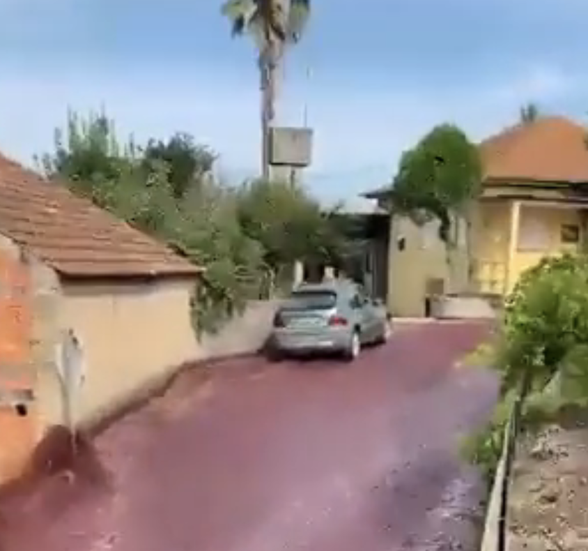 Car parked at the top of the hill in the red wine river