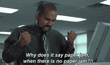 Frustrated man wearing a shirt and tie from &quot;Office Space&quot; saying &quot;Why does it say paper jam when there is no paper jam?!&quot;