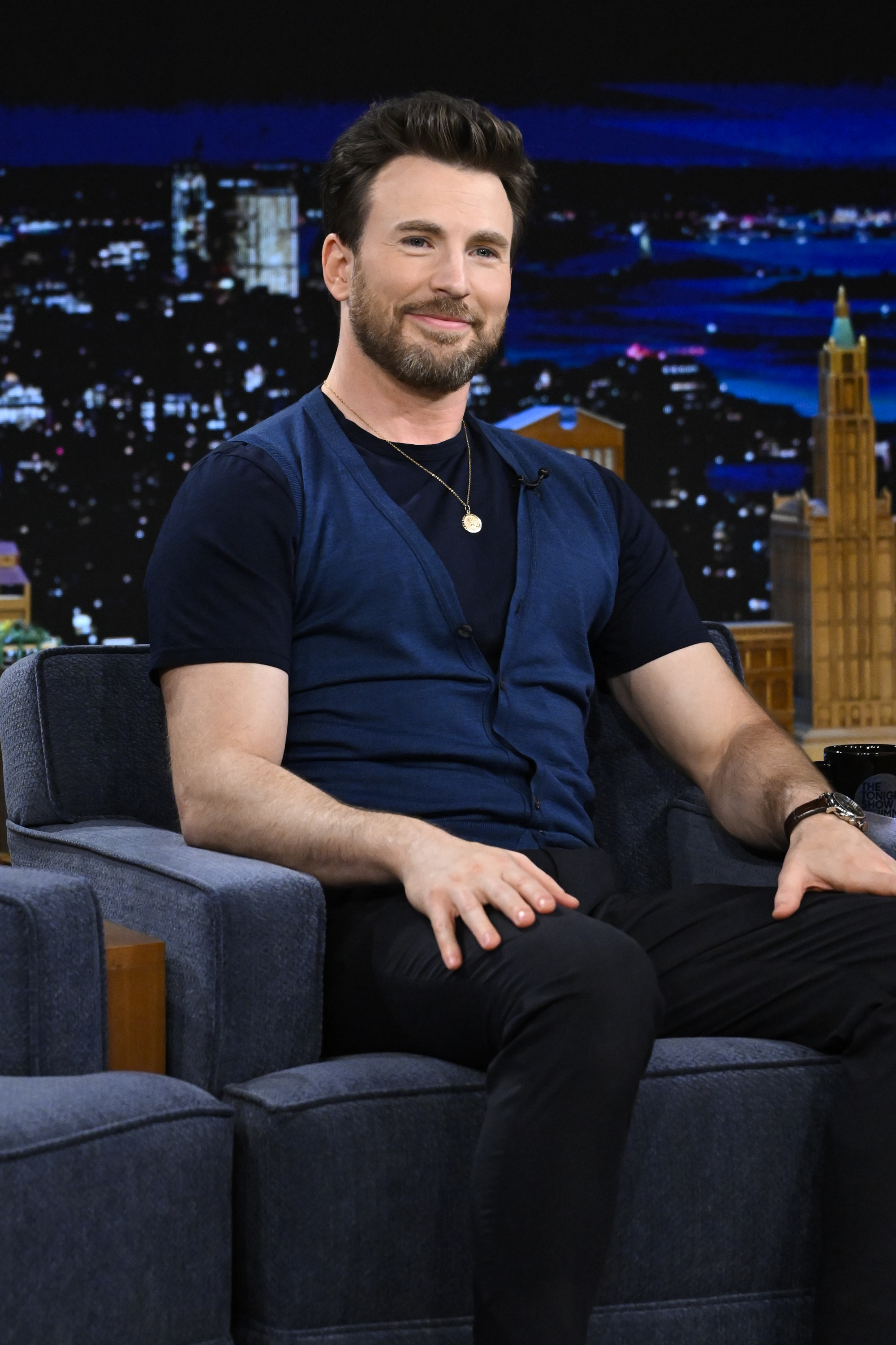 Chris sitting onstage for a late night TV talk show