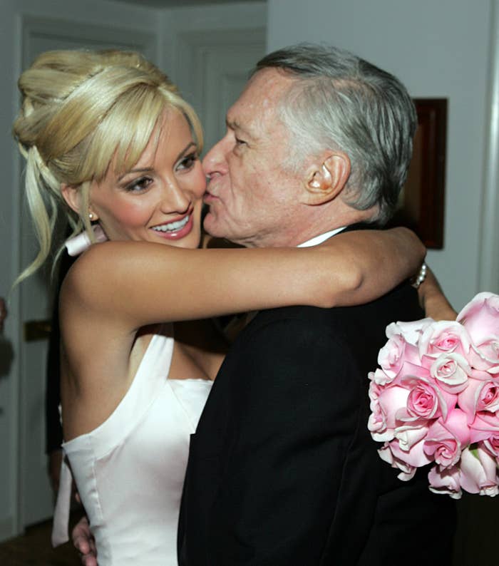 Holly Madison hugging Hugh Hefner as he kisses her on the cheek