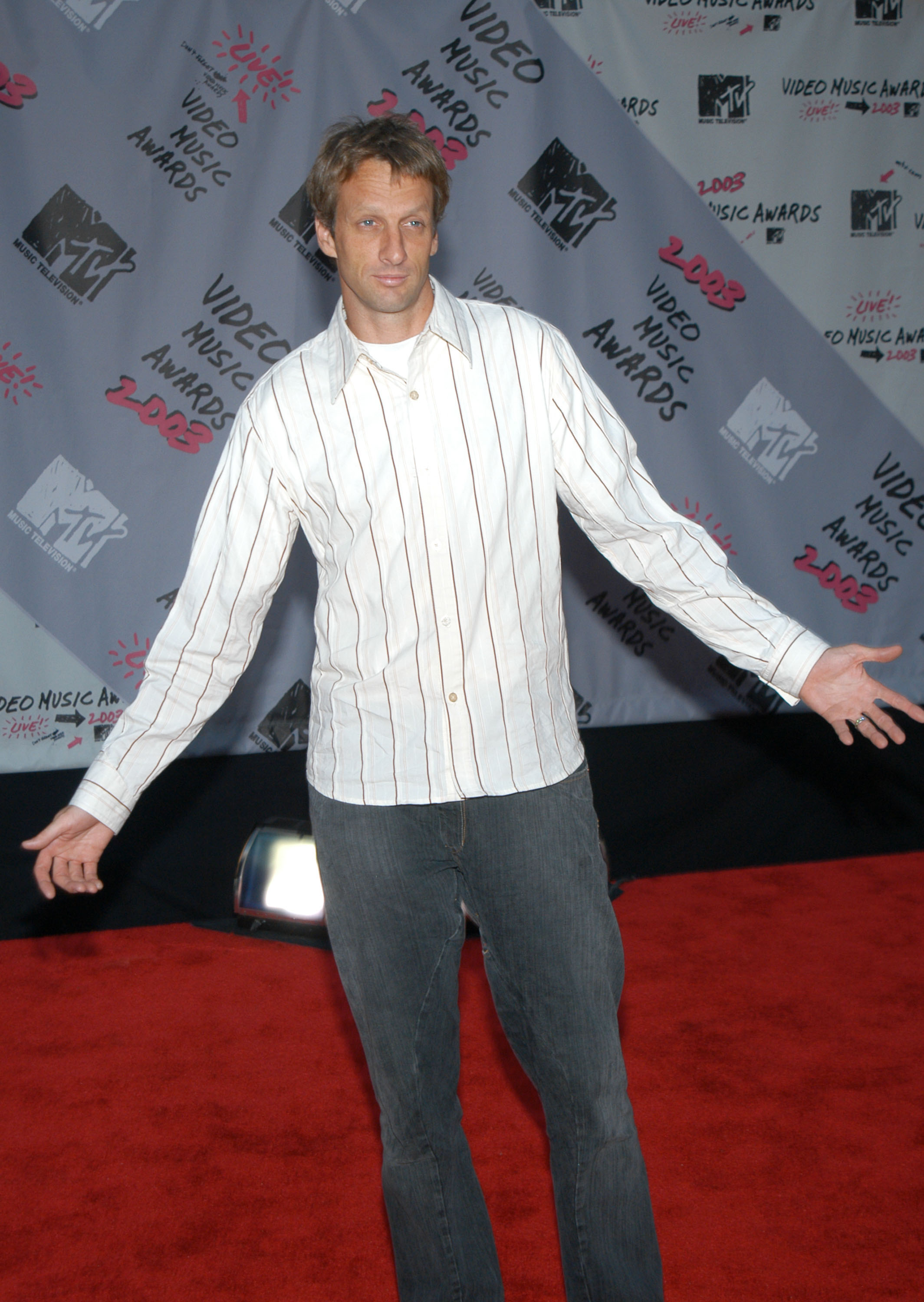 closeup of him in jeans on the read carpet