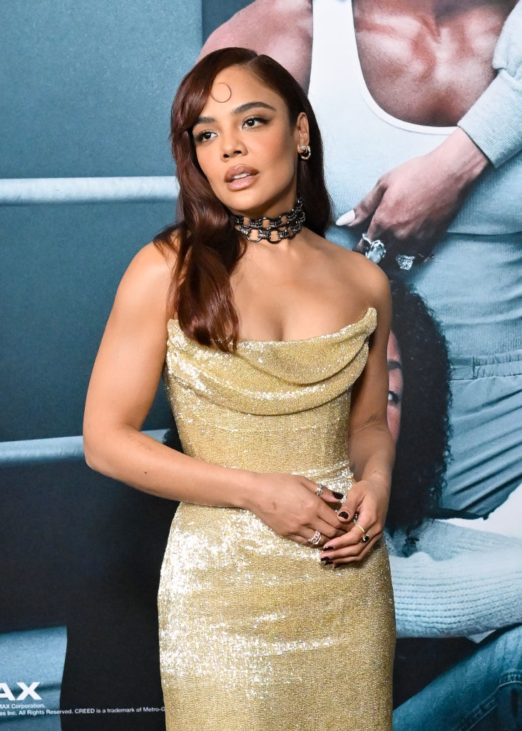 Close-up of Tessa at a media event in a shiny strapless dress