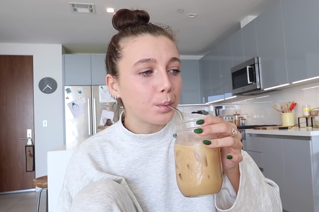 Emma Chamberlain drinking an iced coffee out of a mason jar