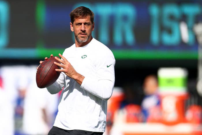Aaron Rodgers throws the football in plain clothes