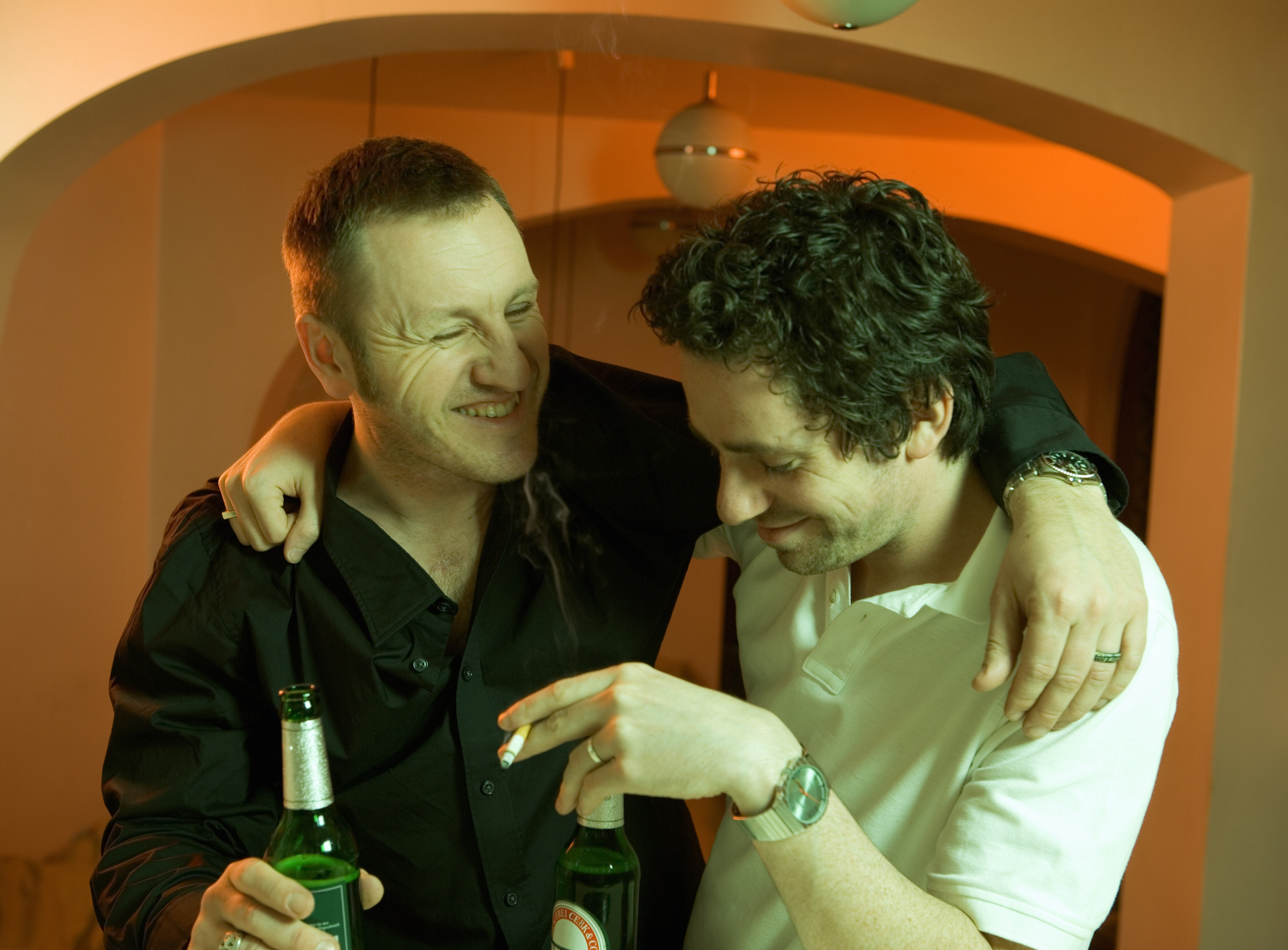 Two men drinking and laughing