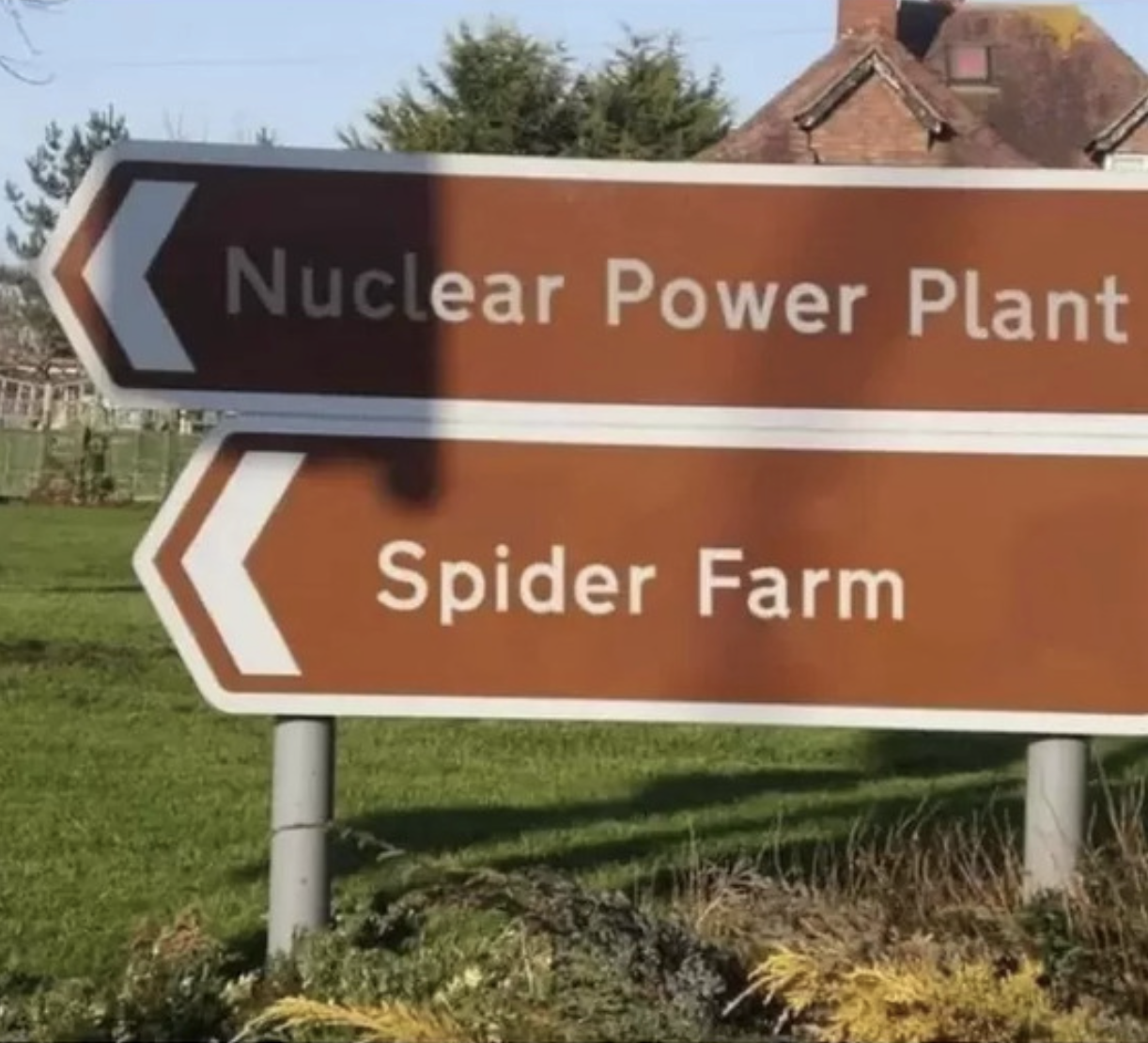 Street directional signs: &quot;Nuclear Power Plant&quot; and &quot;Spider Farm&quot;