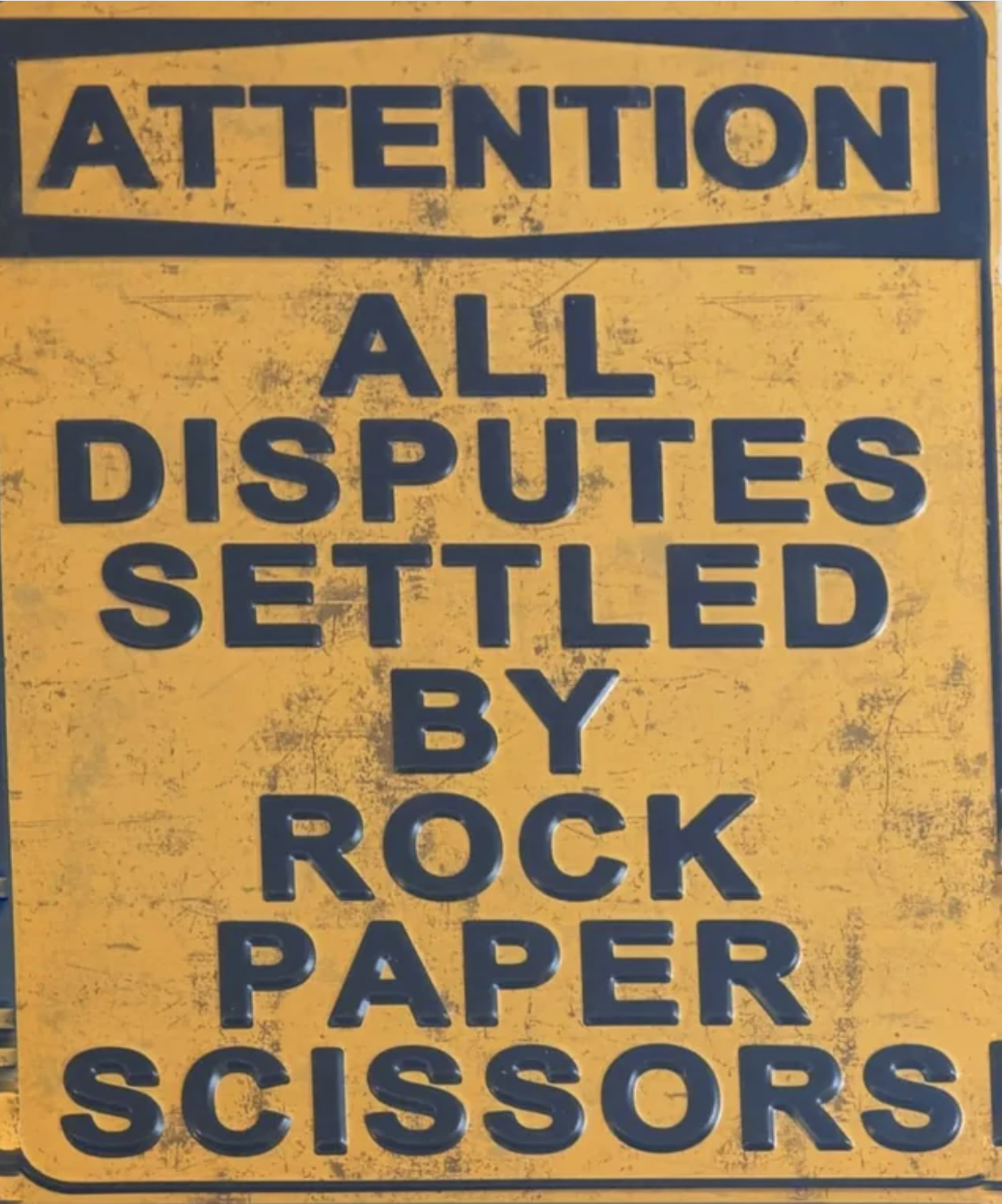 Sign: &quot;Attention: All disputes settled by rock paper scissors!&quot;