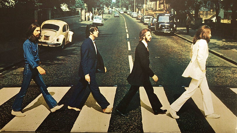 the members walking across the street in their album cover