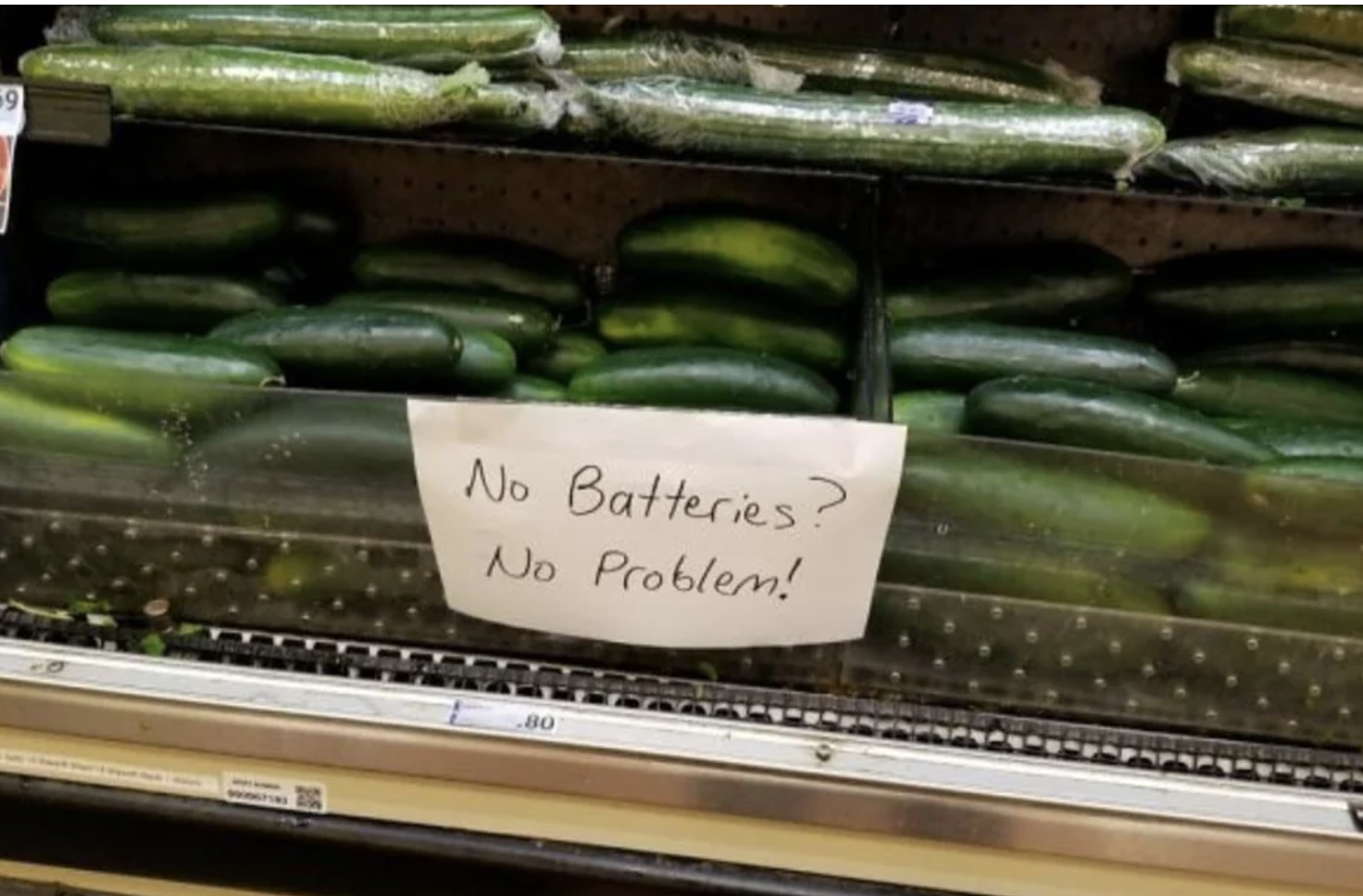 Display of cucumbers with handwritten sign: &quot;No batteries? No problem!&quot;