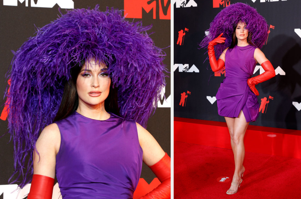 her on the red carpet wearing a large hat that almost looks like a wig