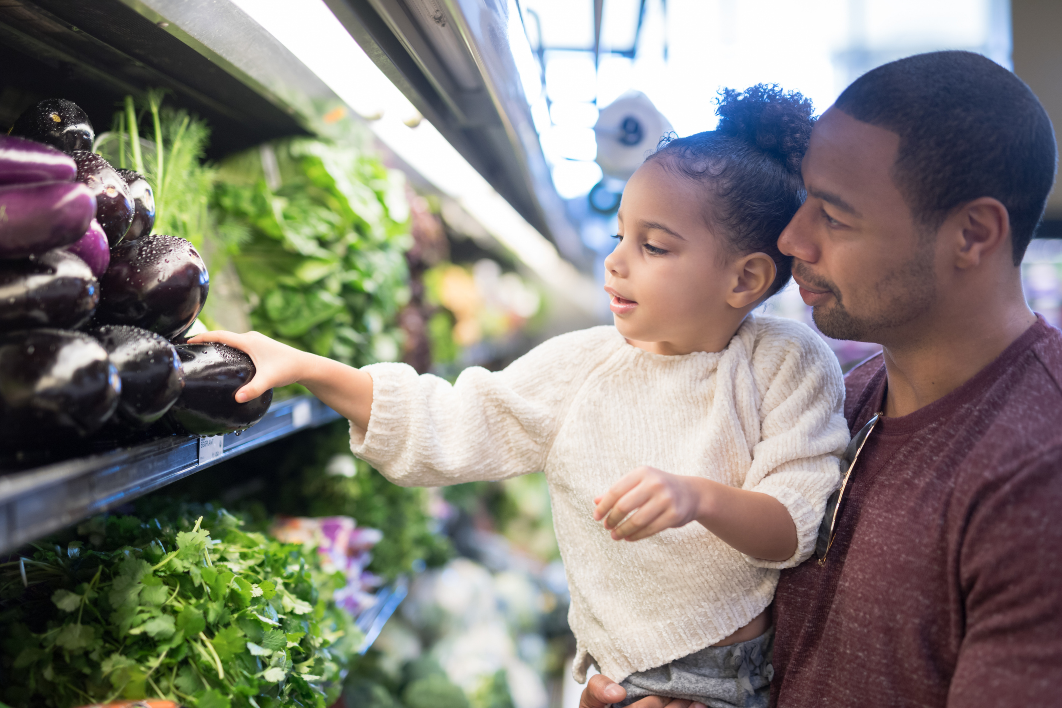 child touching produce