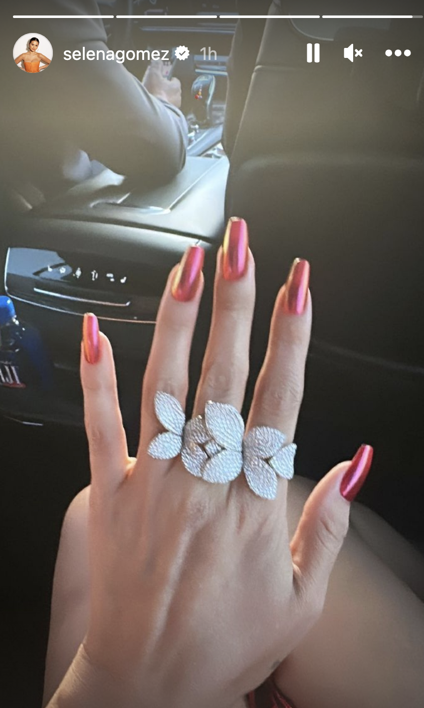 her nails to match her dress and a large floral diamond ring