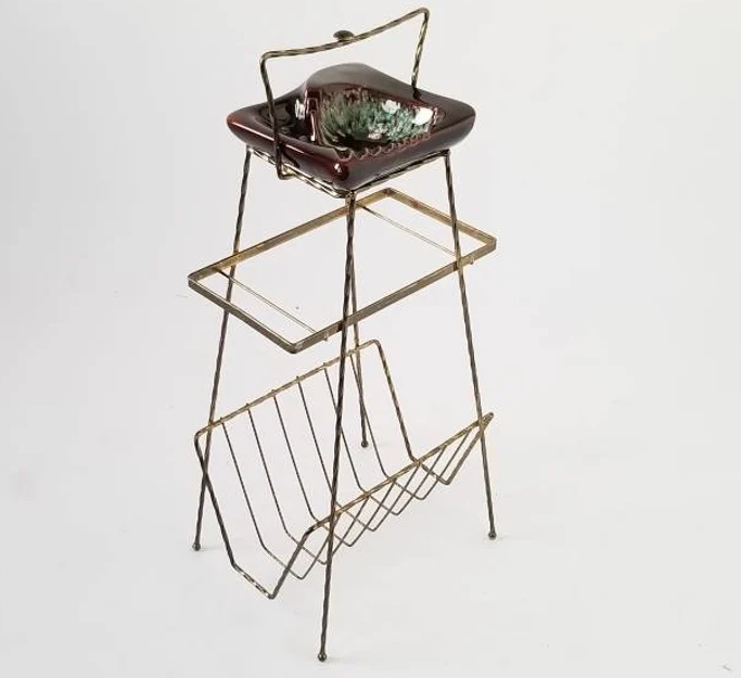 tall ash tray table with a magazine rack on the base