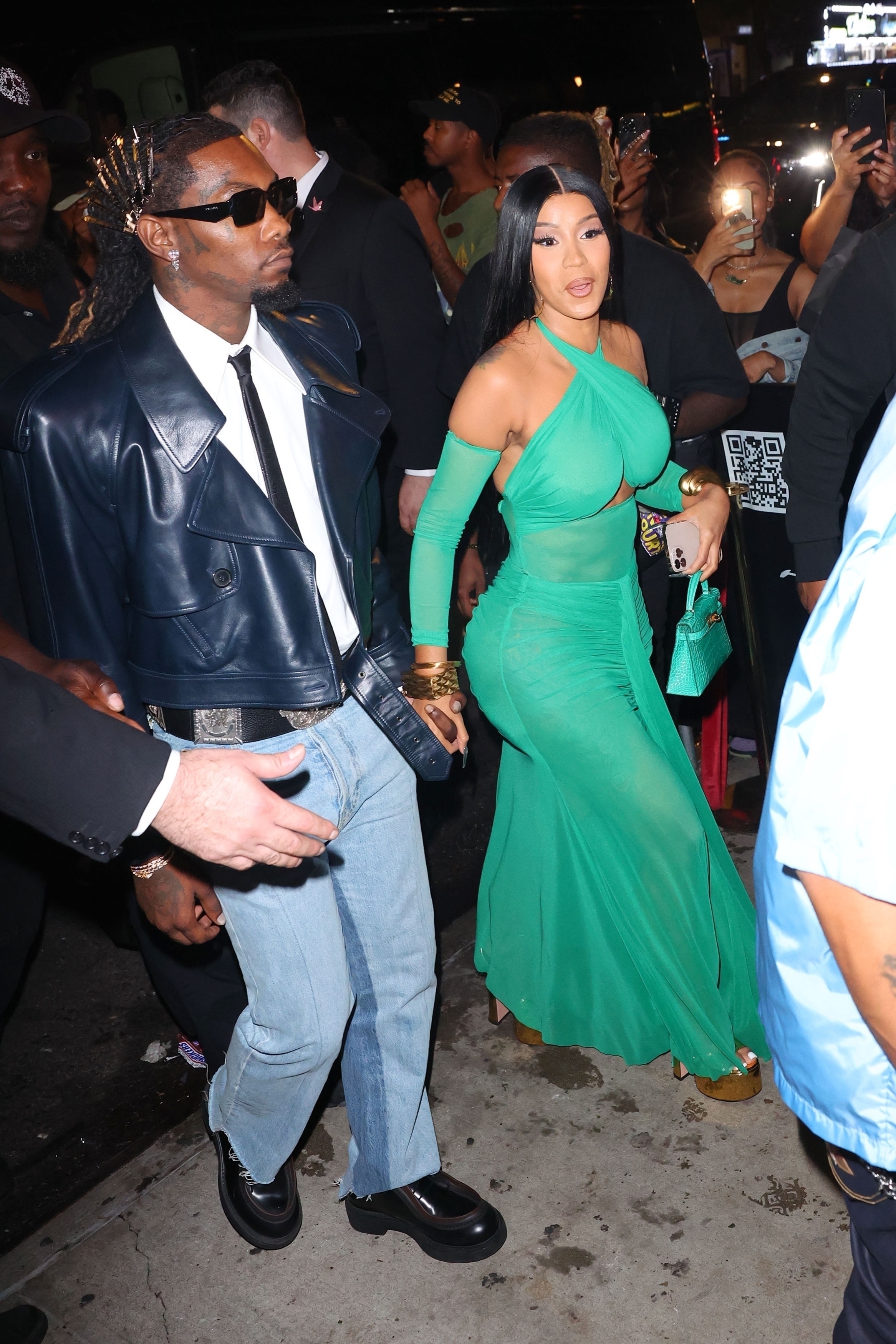 cardi is wearing a long halter dress and offset is in jeans and a cropped leather jacket