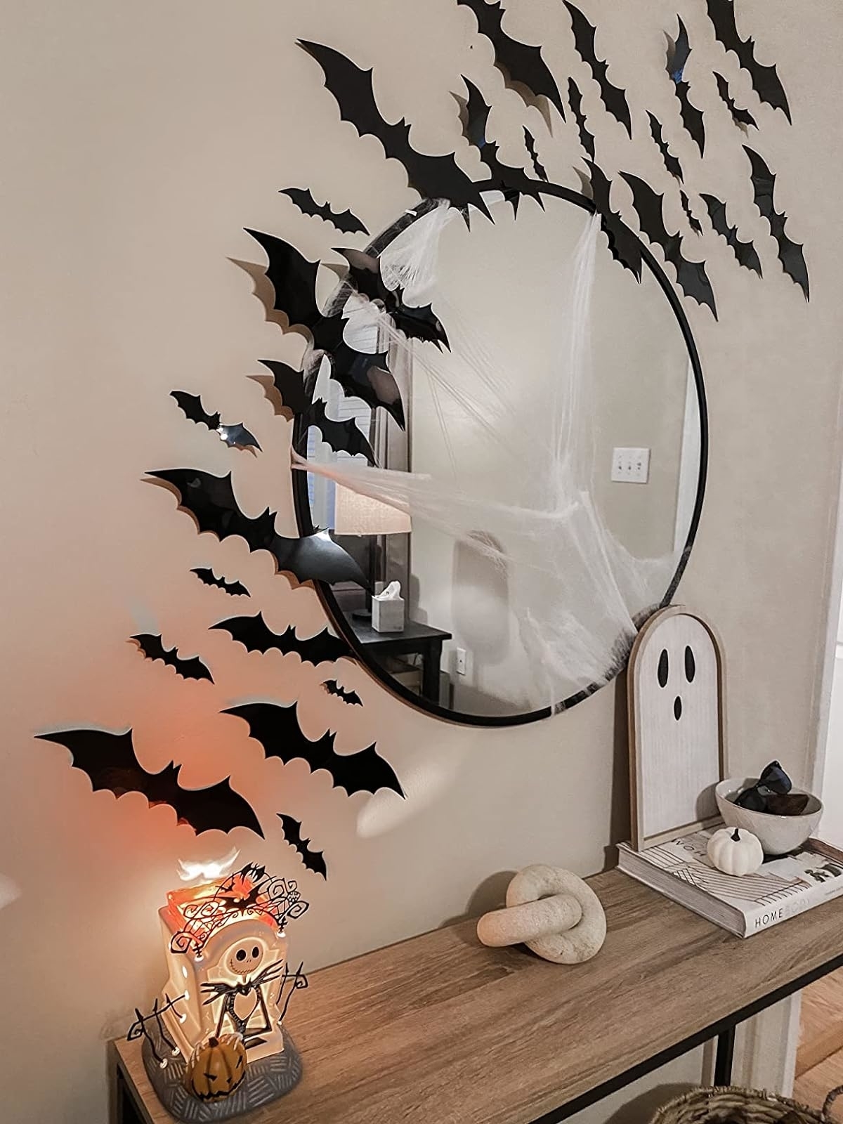 Reviewer image of the bats stuck on the wall around a mirror above a console