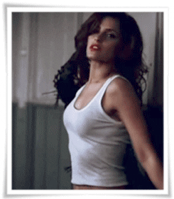 Gif of Nelly Furtado dancing looking at the camera.