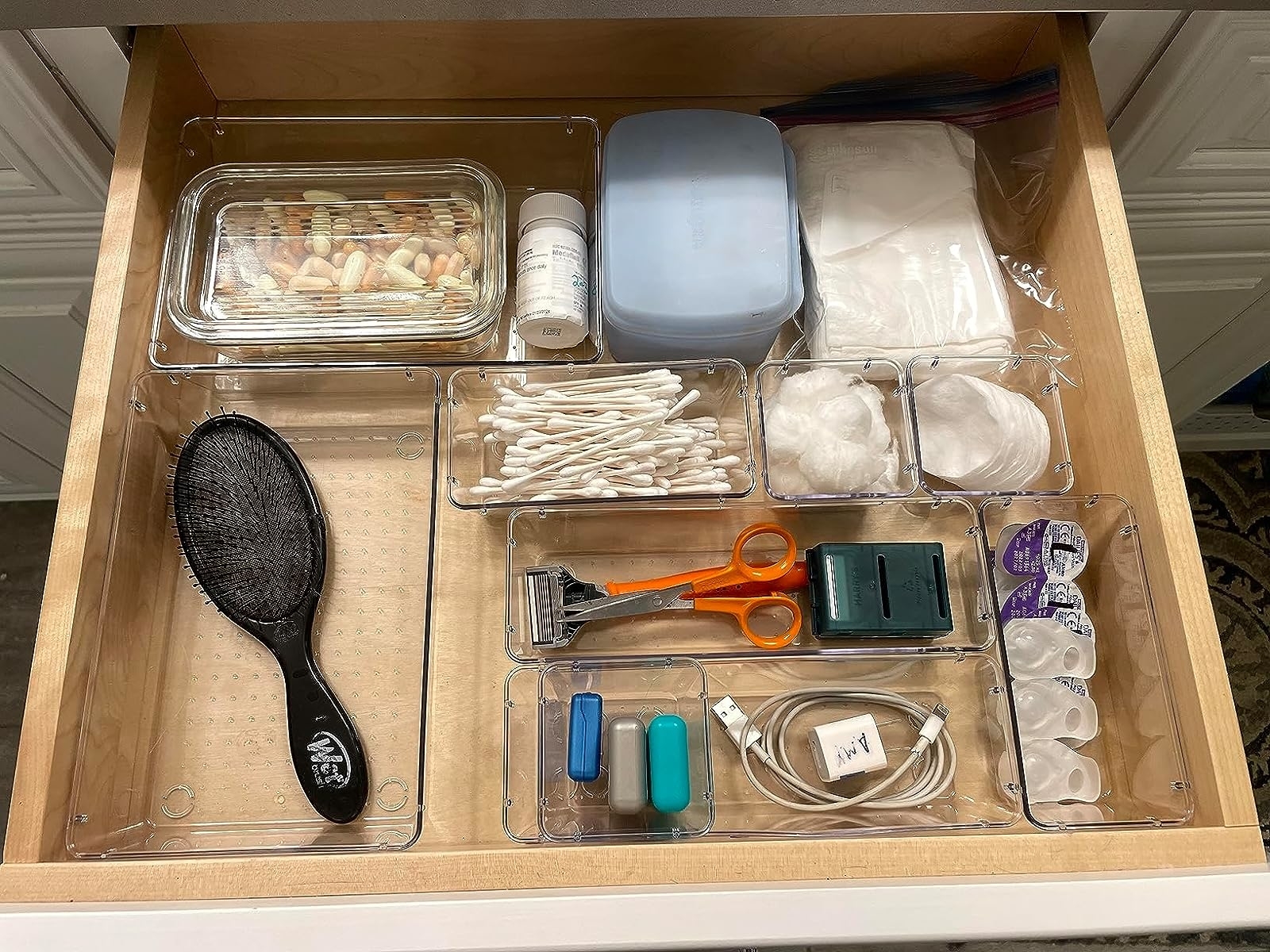 Reviewer image of the clear organizers used in a bathroom drawer