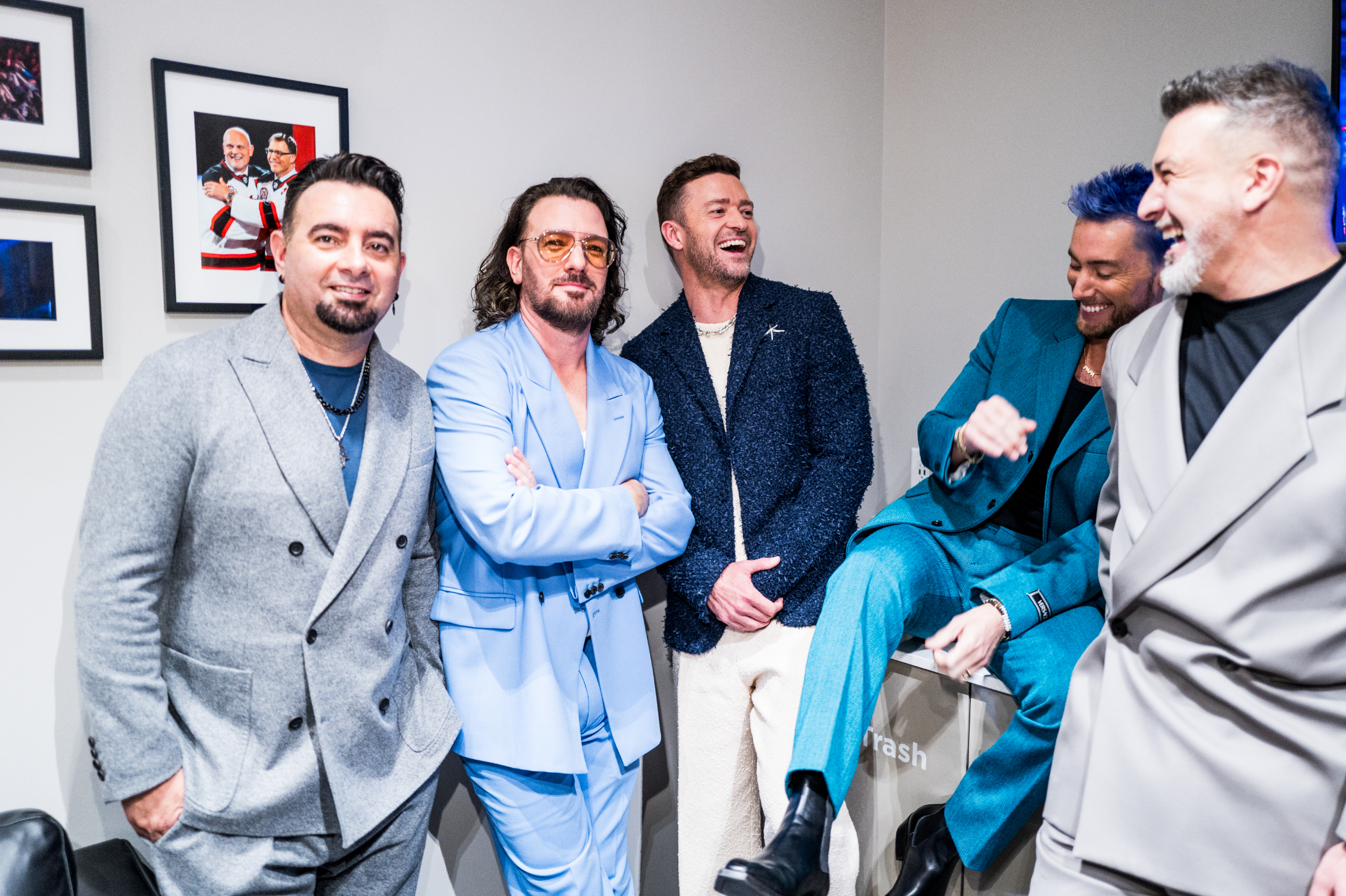 The members of NSYNC smiling and standing together