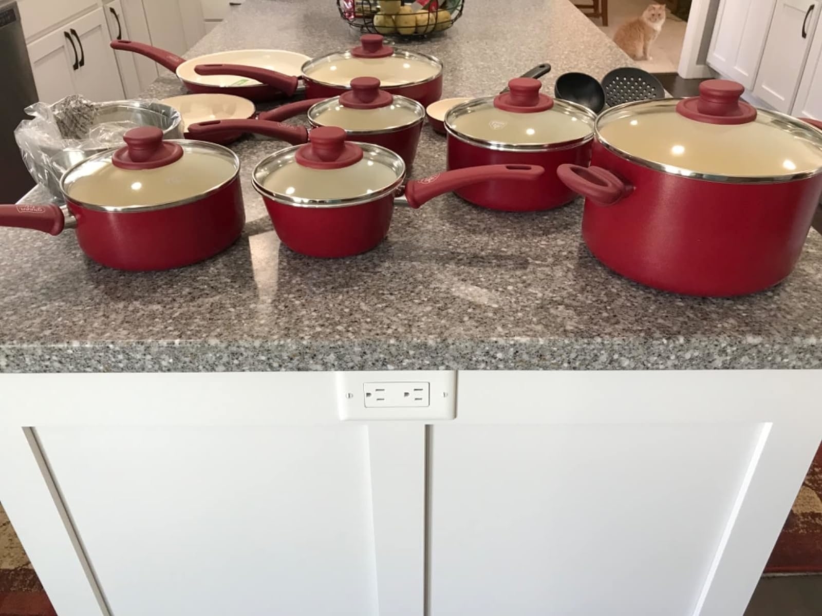 Reviewer image of the red cooking pots on their kitchen countertop