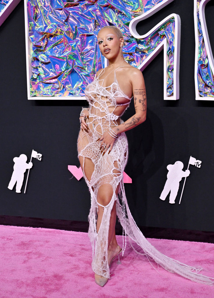 her dress looks like strings of fabric to resemble a cobweb on her