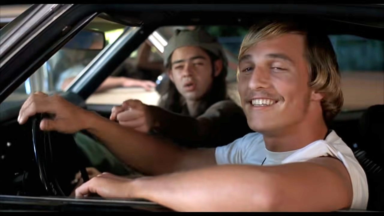 him smiling in a car in the film