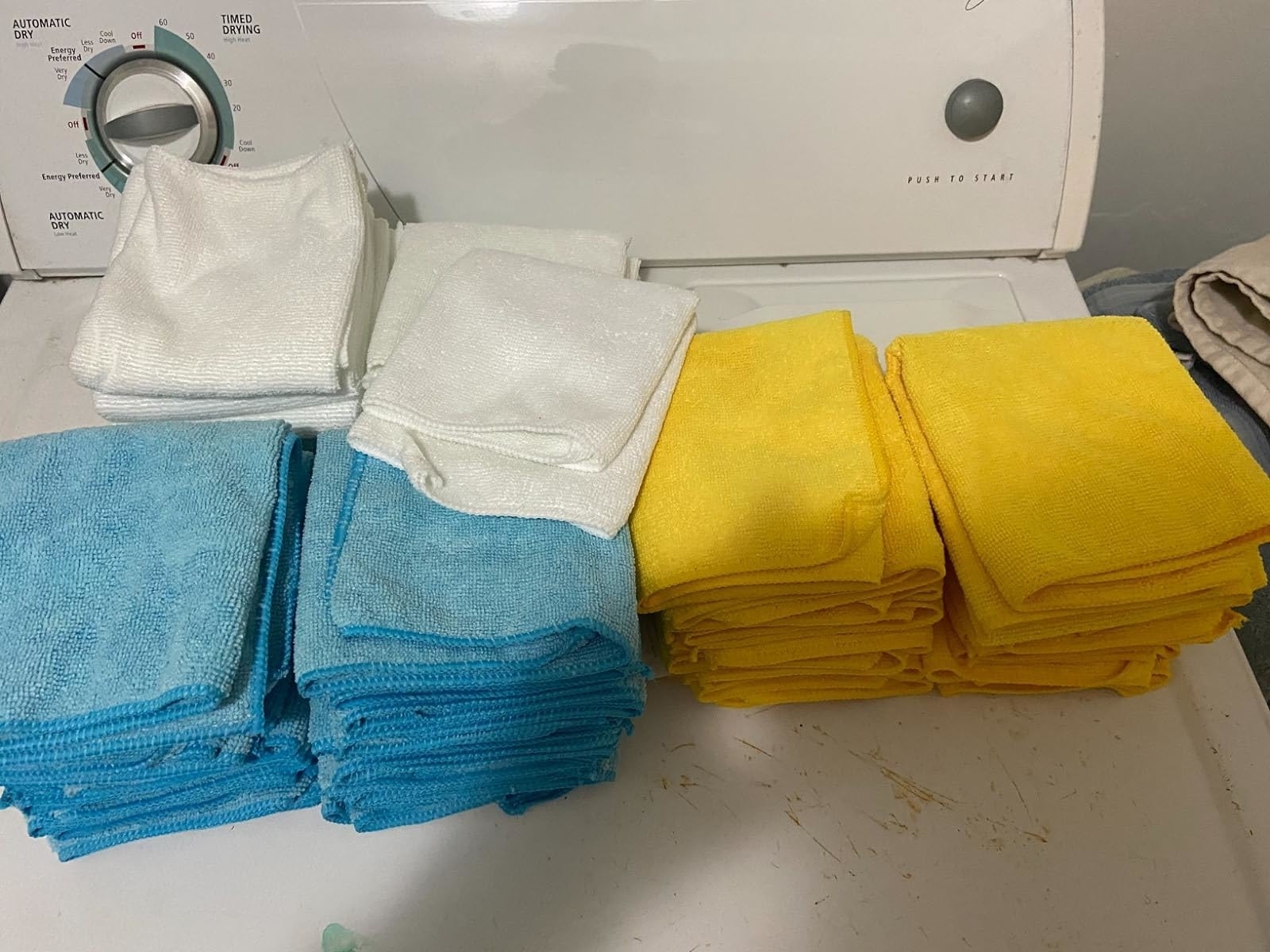 Reviewer image of the blue, yellow, and white microfiber cloths