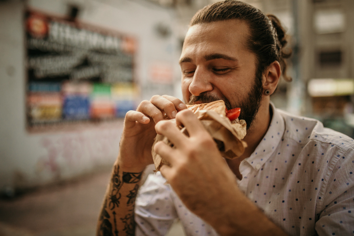 guy taking a bite of food