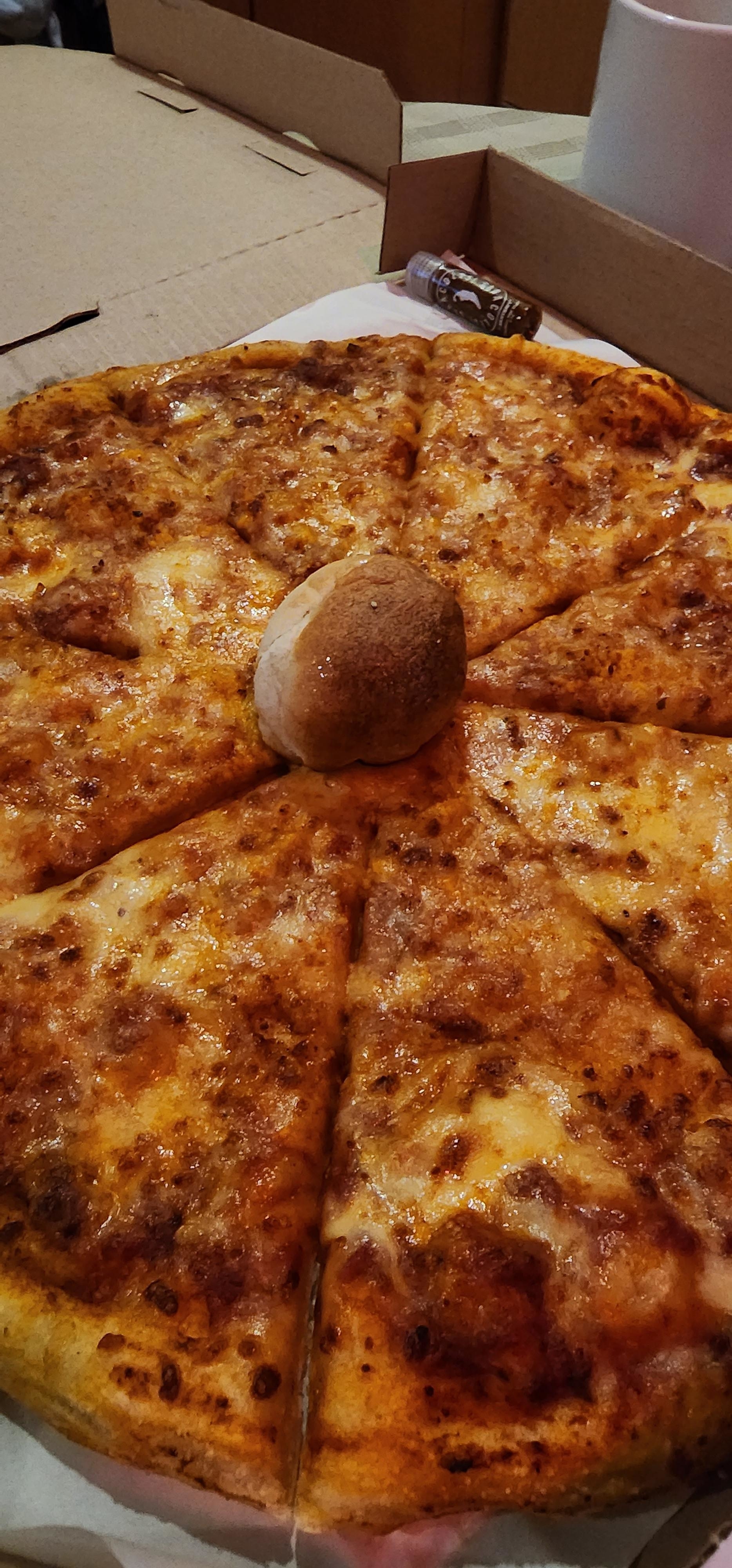 cooked dough ball in the center of a pizza