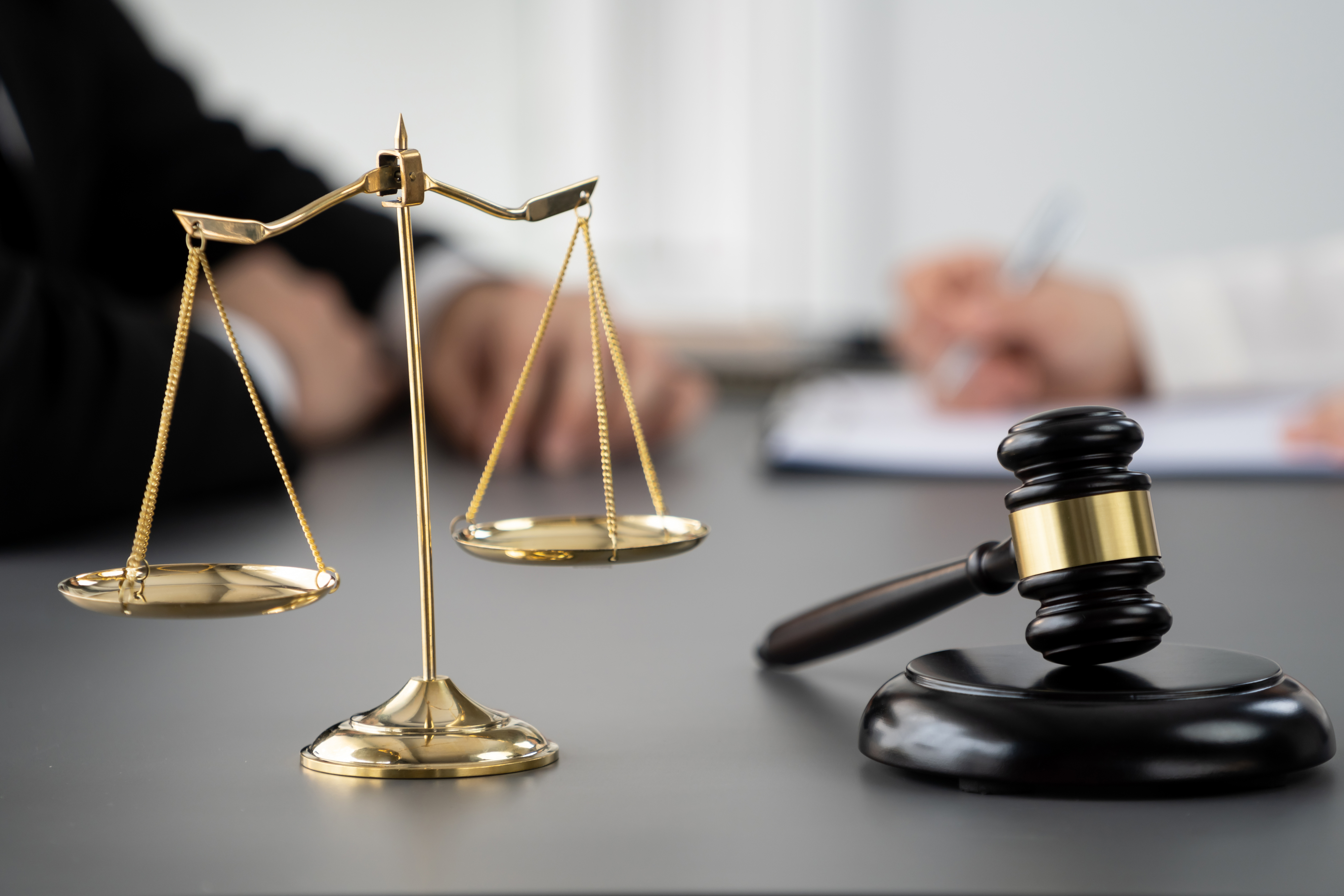 desk decorated with the scales of justice and a gavel