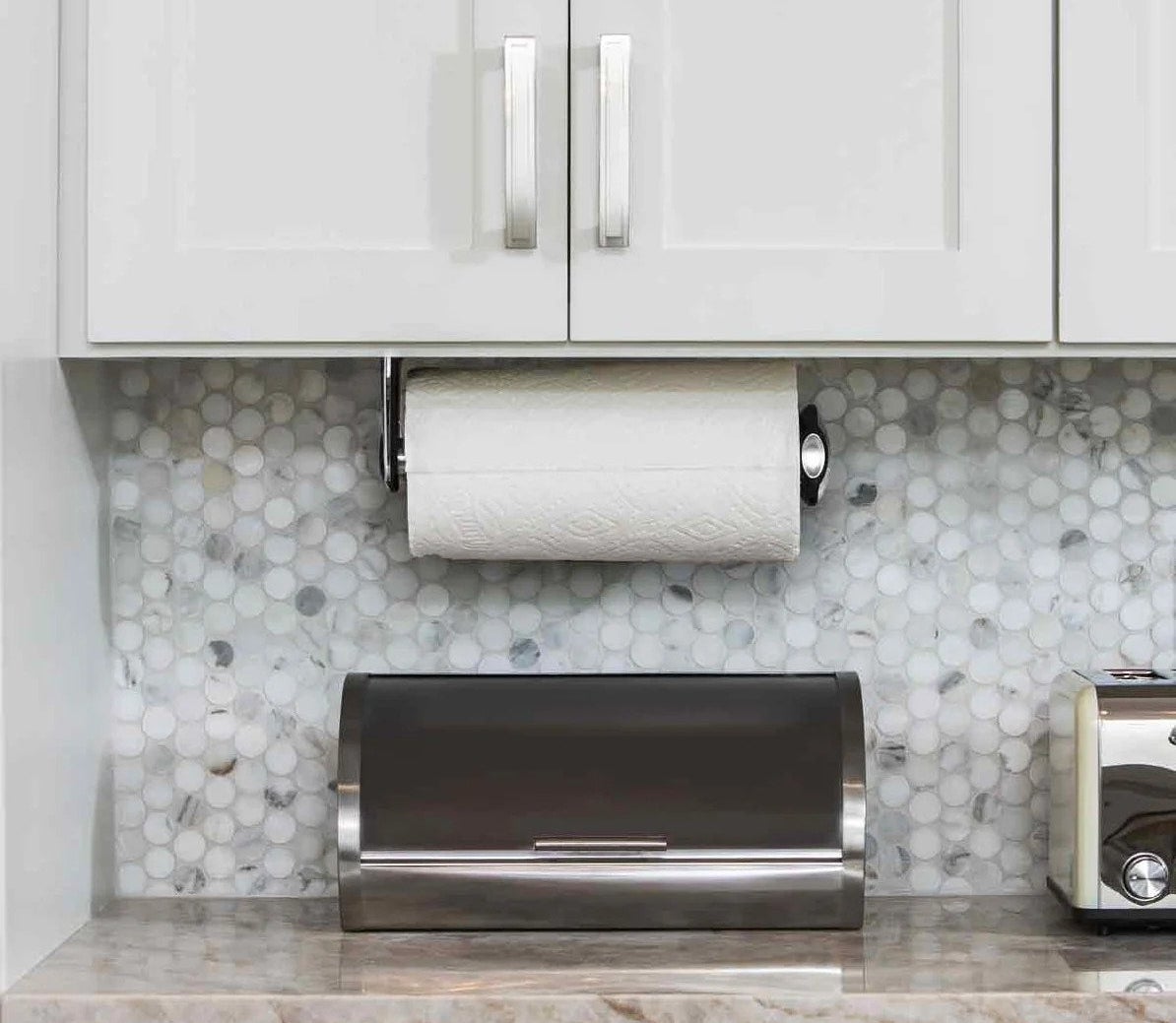 The paper towel holder mounted under cabinets