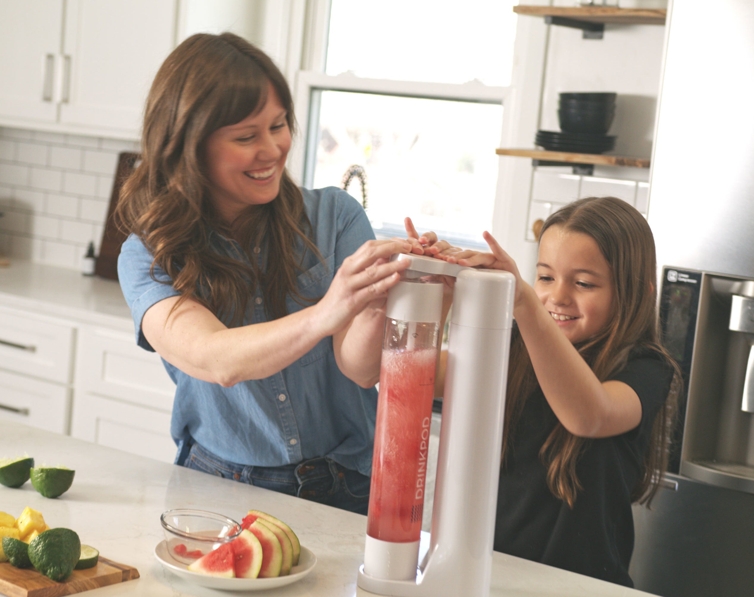 A parent and child operating the fizzy drink machine