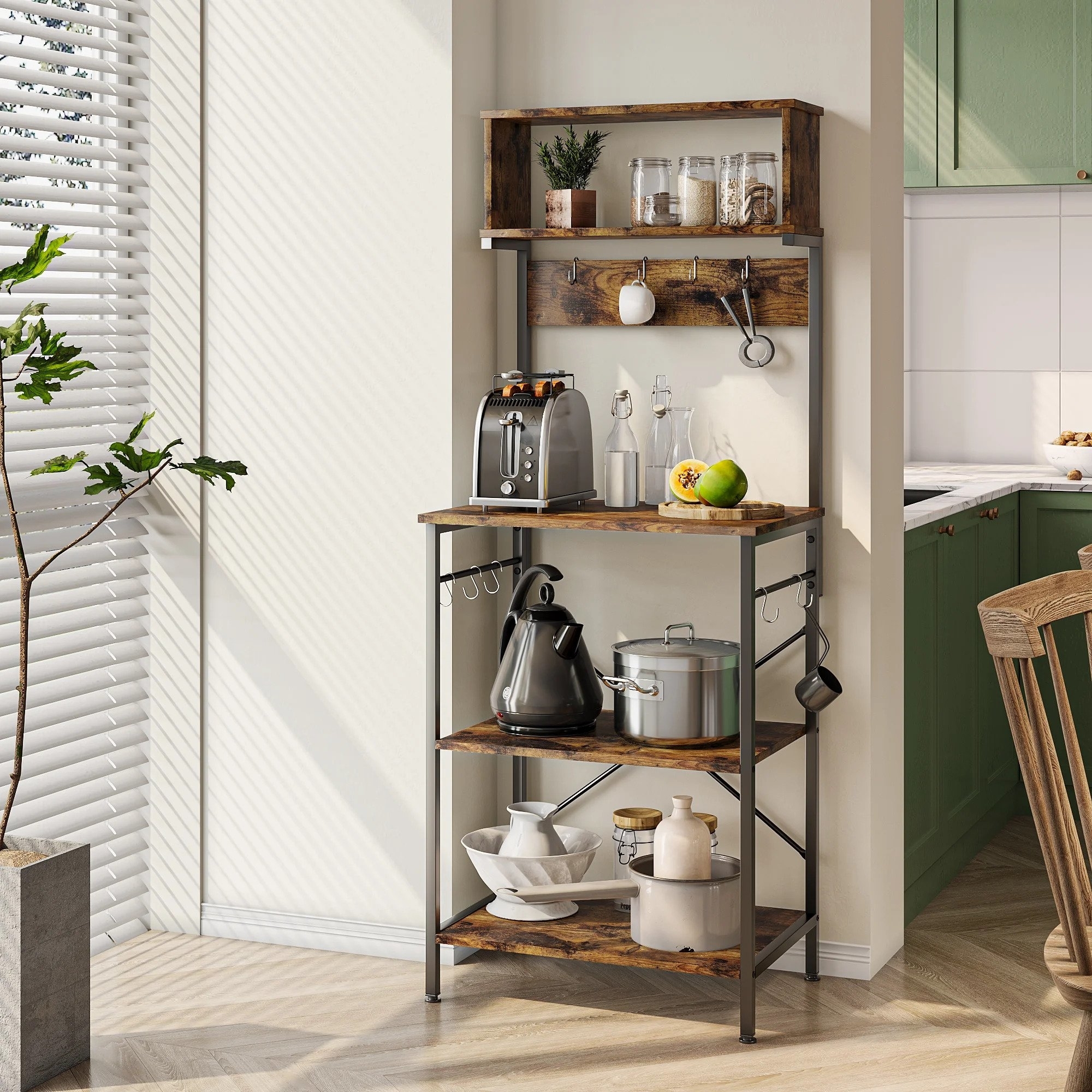 The baker&#x27;s rack with two bottom shelves, one upper shelf, and hooks on the side in a brown wood finish