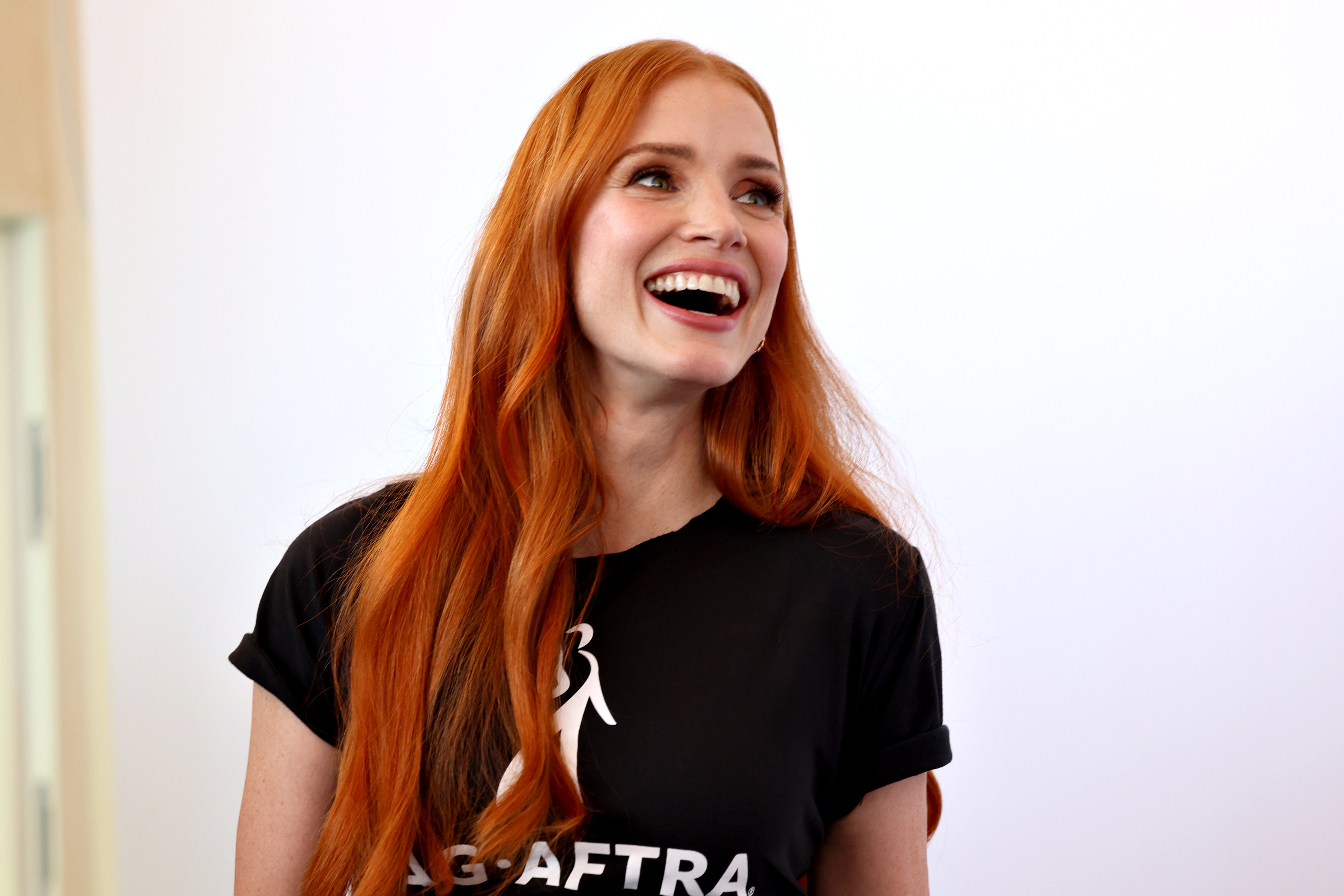 Close-up of Jessica smiling and wearing a SAG-AFTRA T-shirt