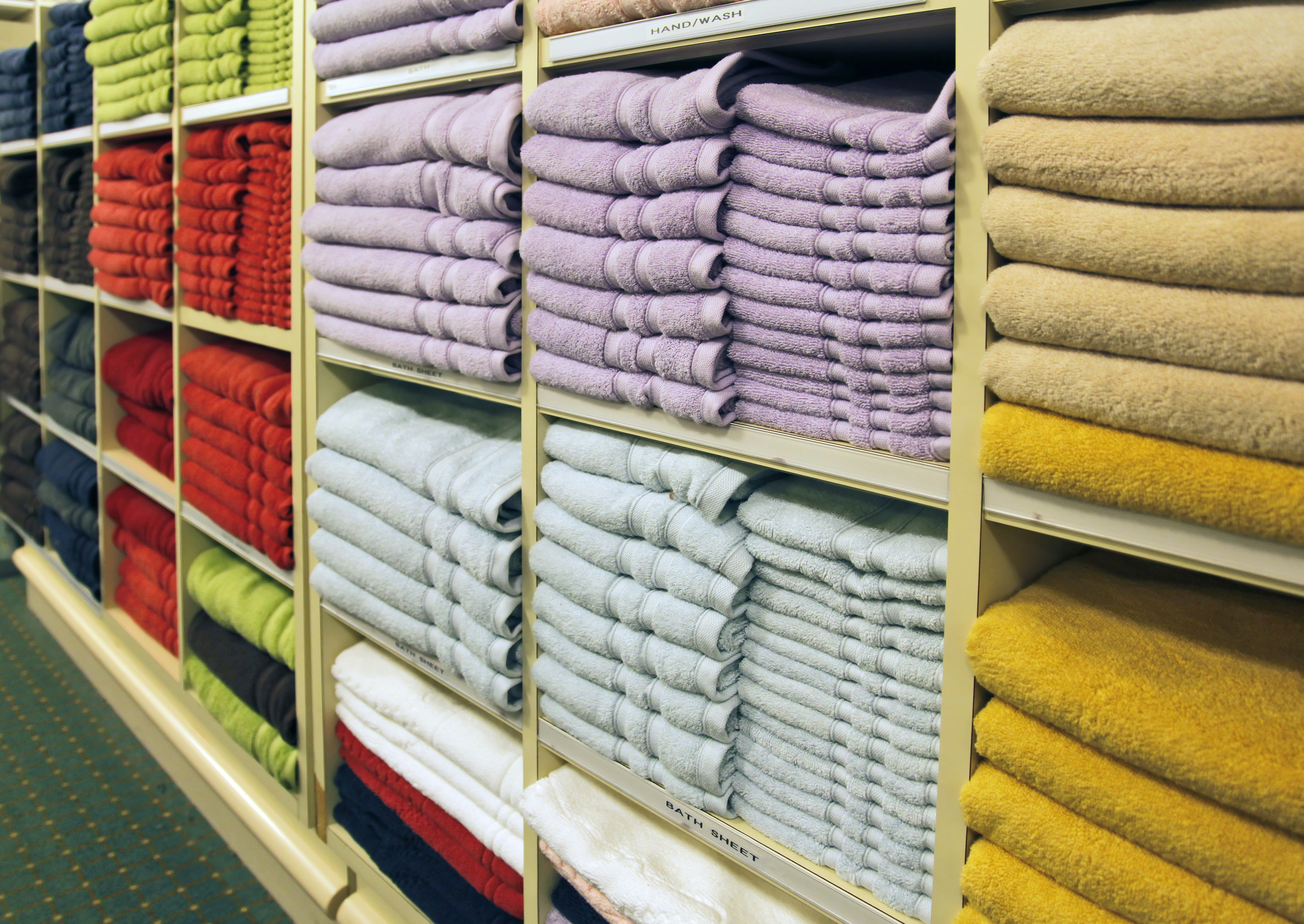 A wall of towels for sale in a store