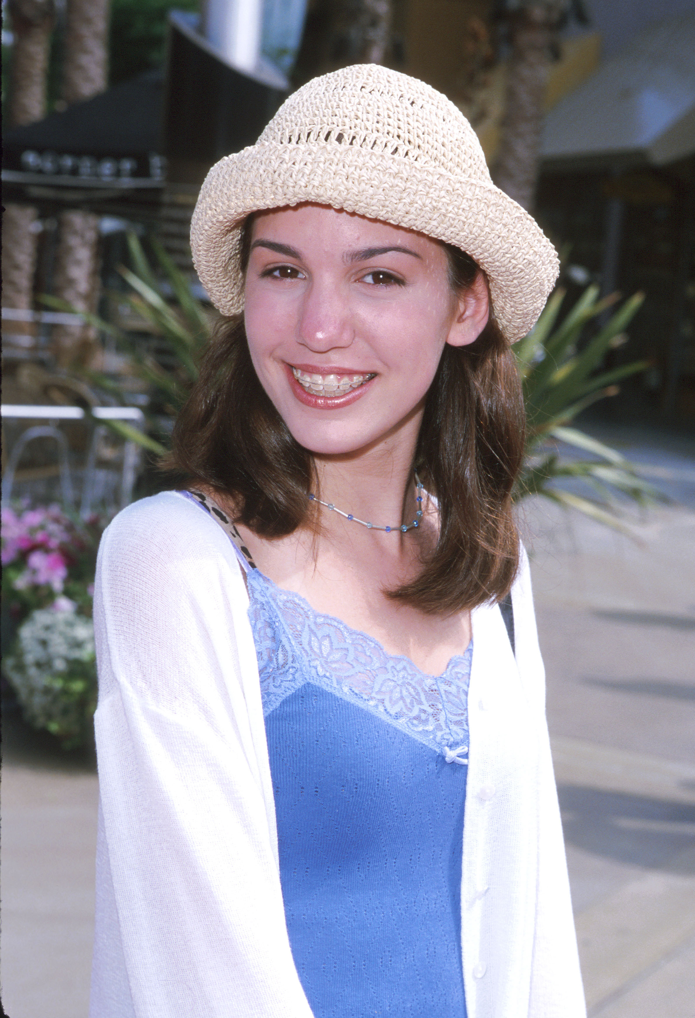 past photo of christy wearing a sun hat