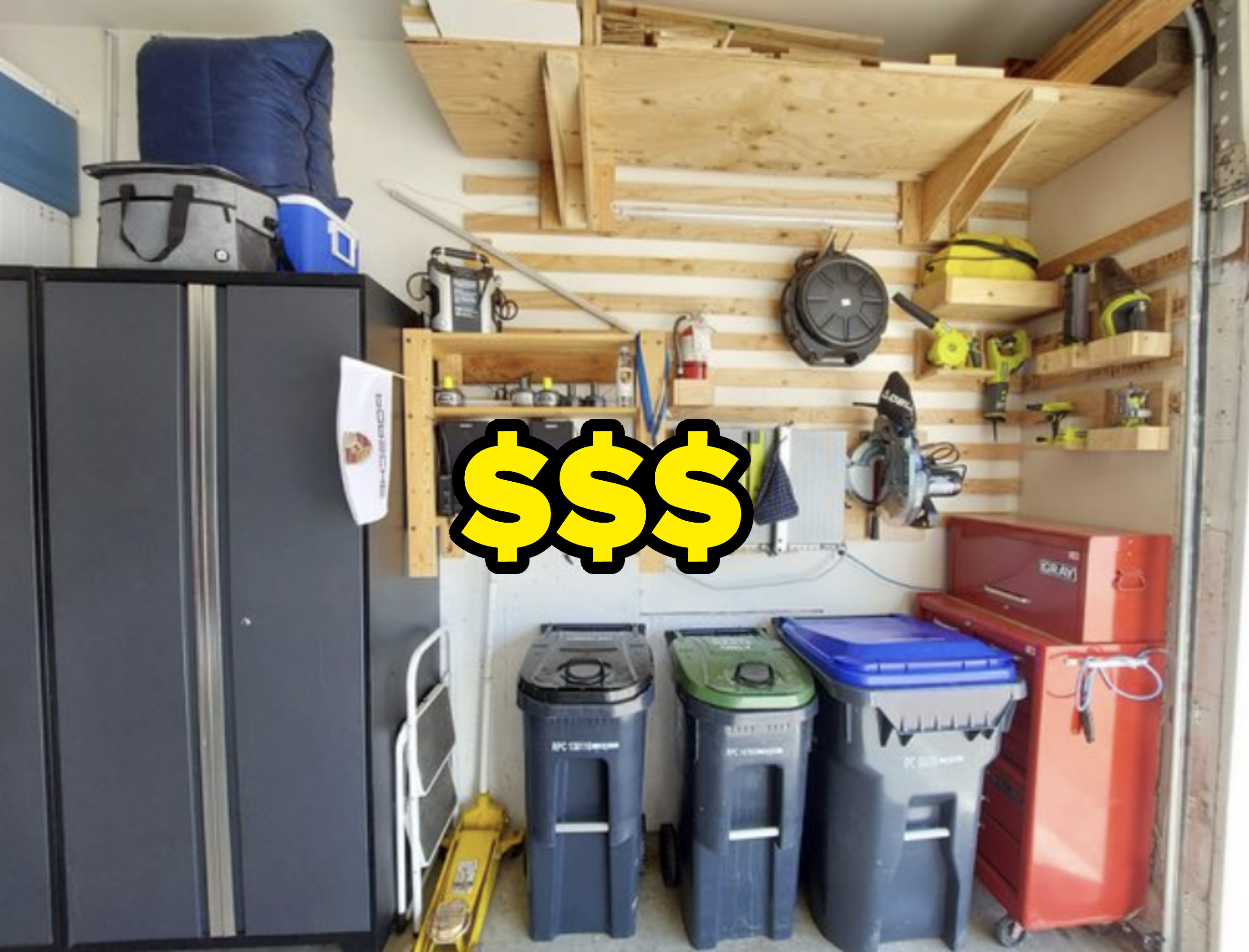 A garage wall that has garbage bins, power tools, and storage