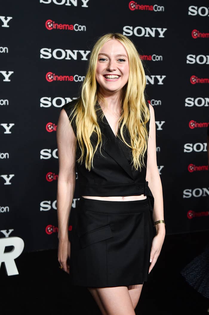 Smiling Dakota wearing a short skirt and crop top