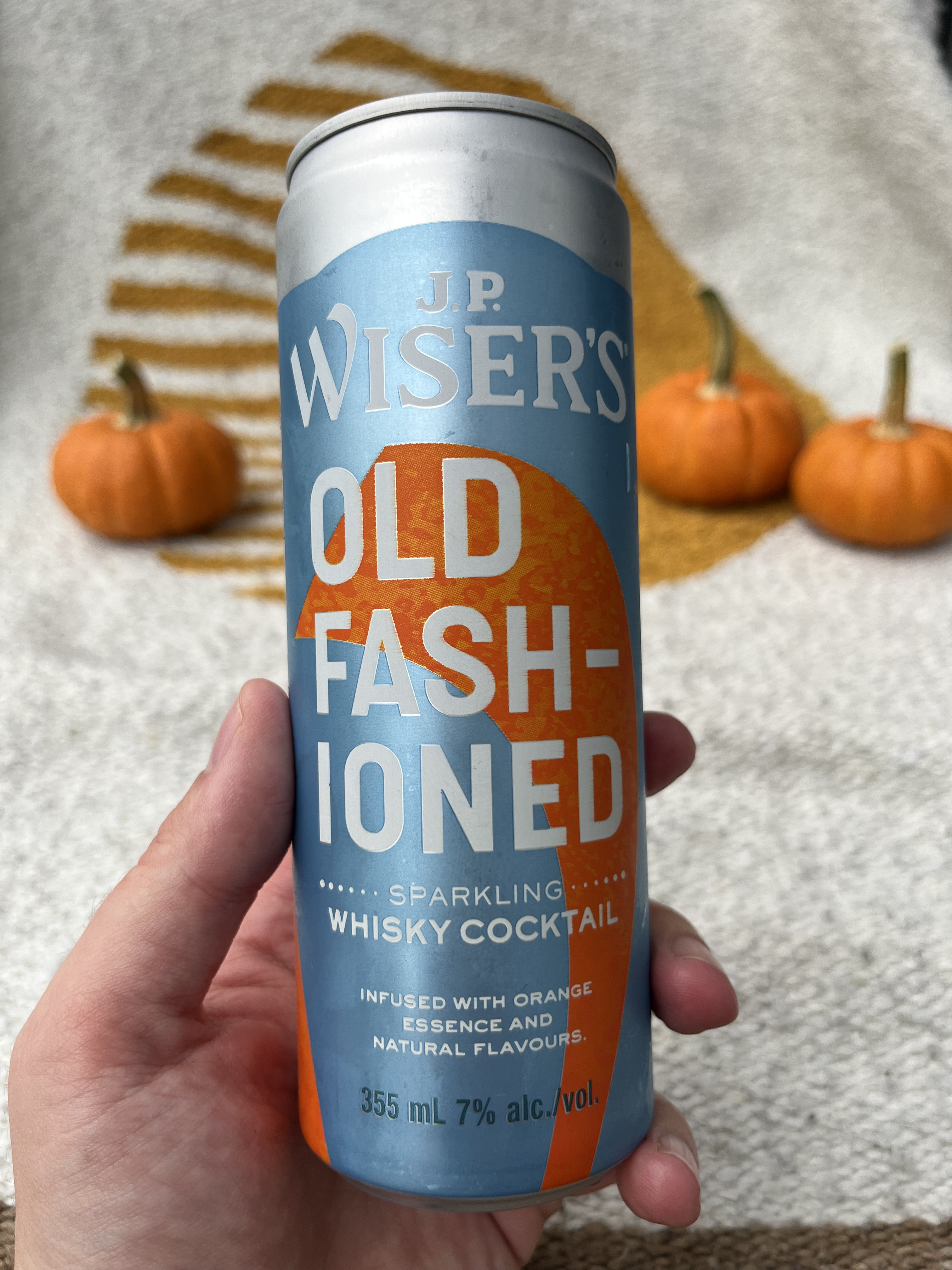 hand holding a can of old fashioned sparkling whisky cocktail