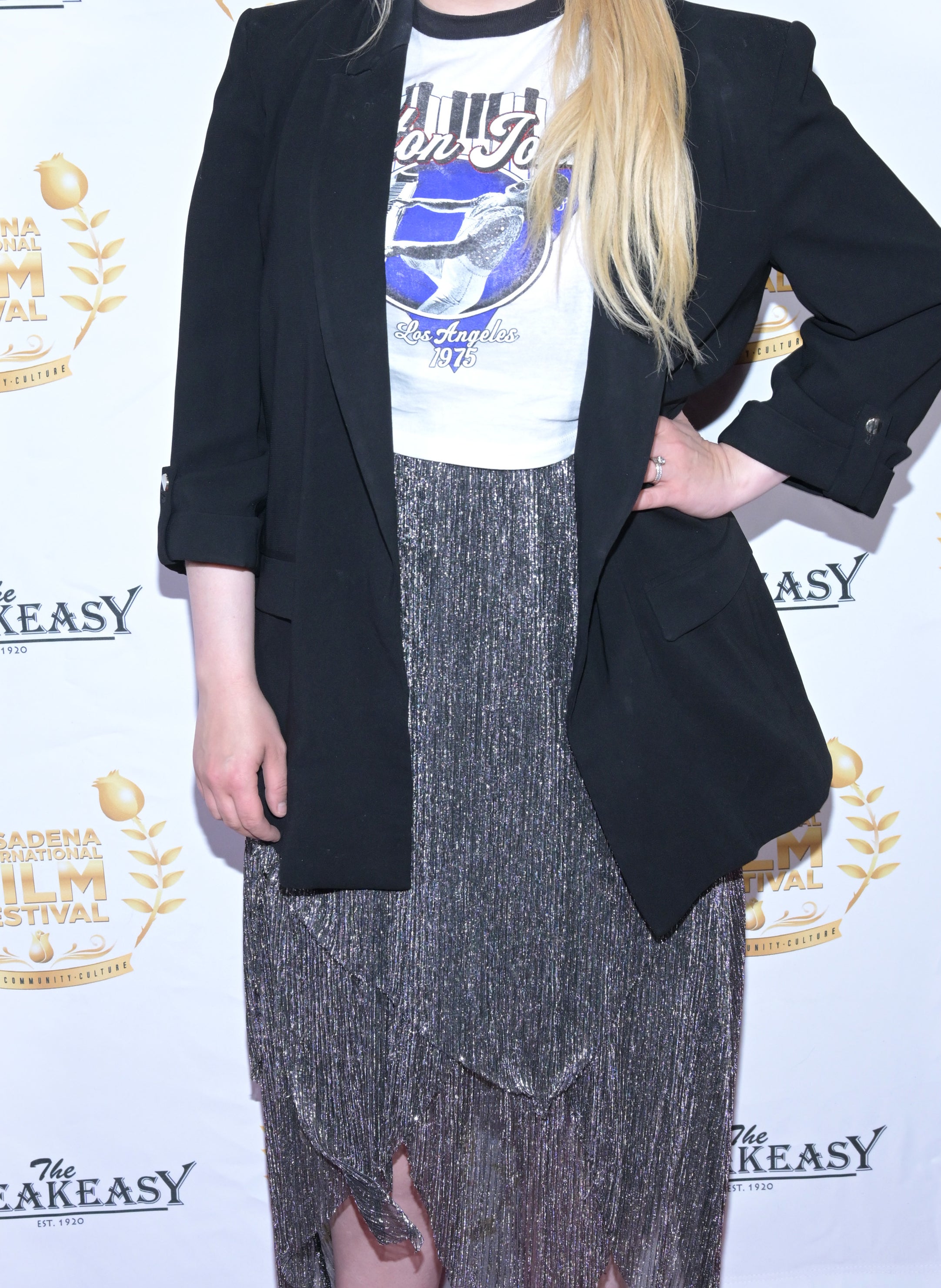 Abigail in a long suit jacket and graphic T-shirt
