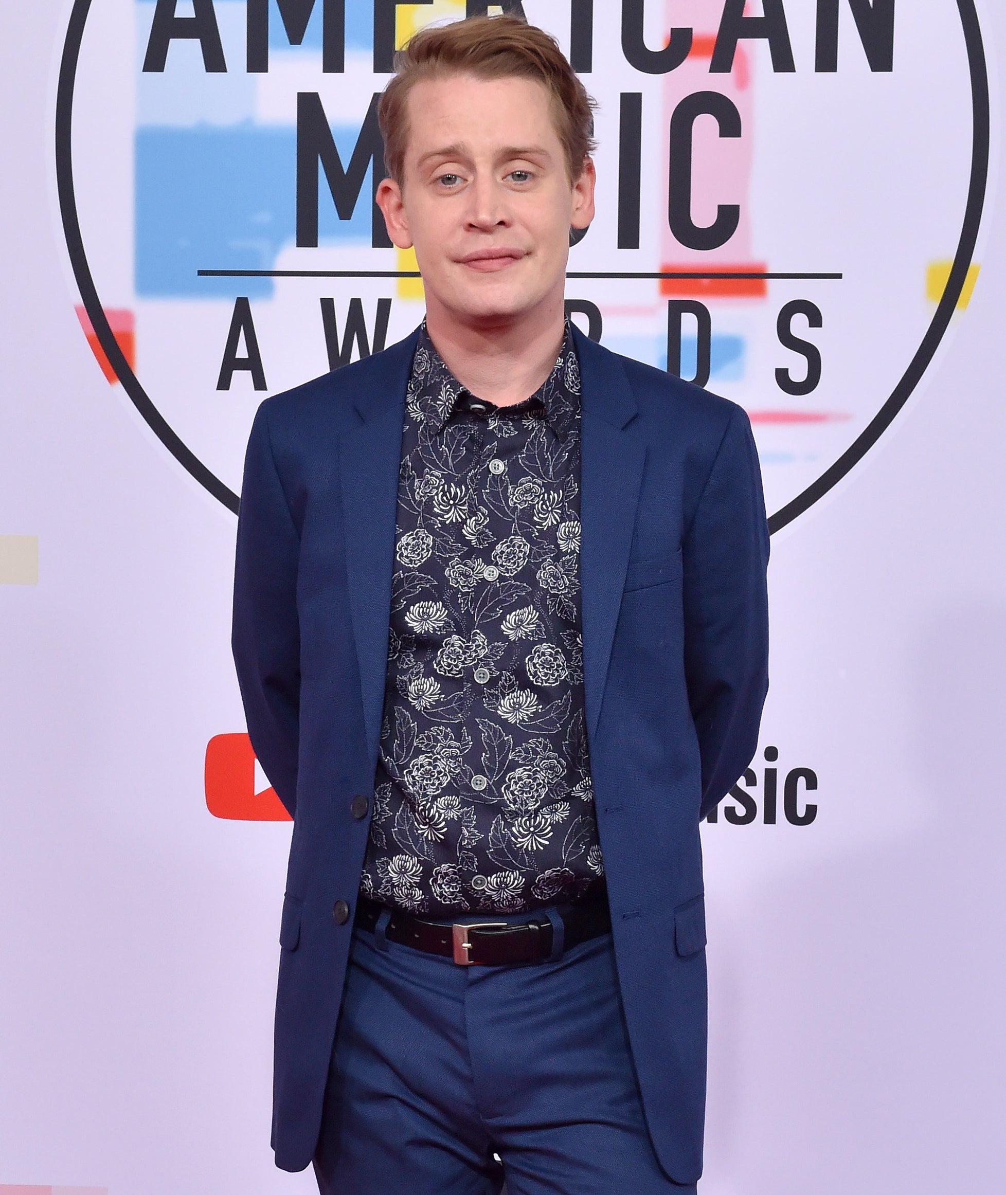 Macauley in a suit and print shirt