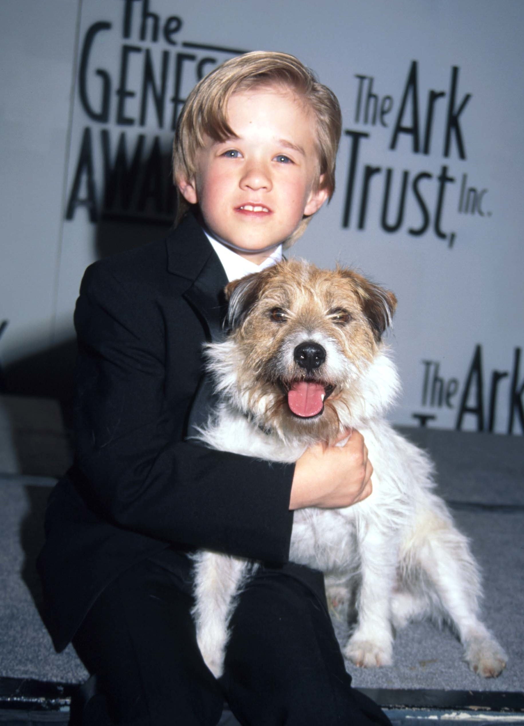 Haley wearing a suit and holding a dog